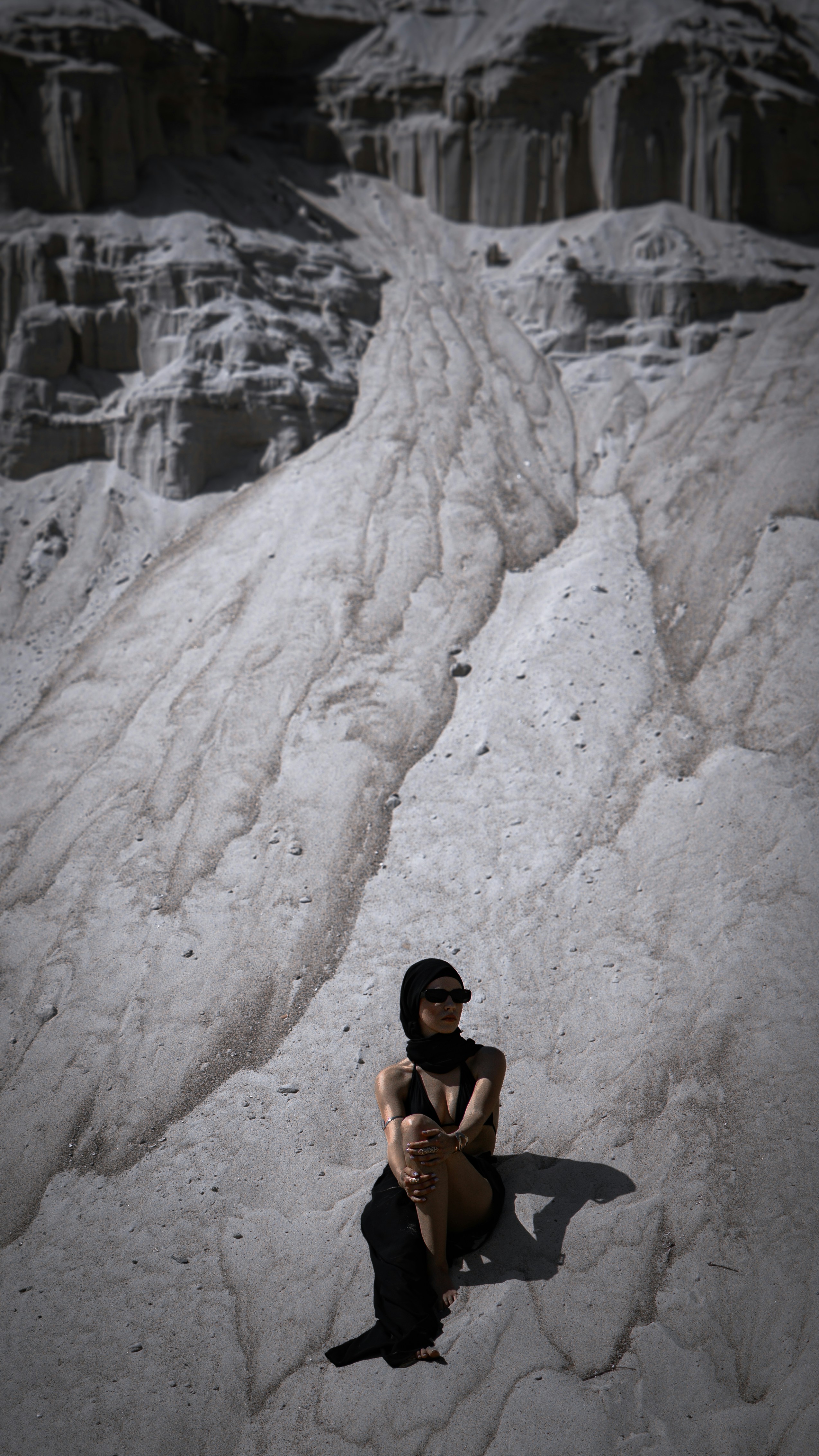 Woman posing in a sandy, eroded landscape