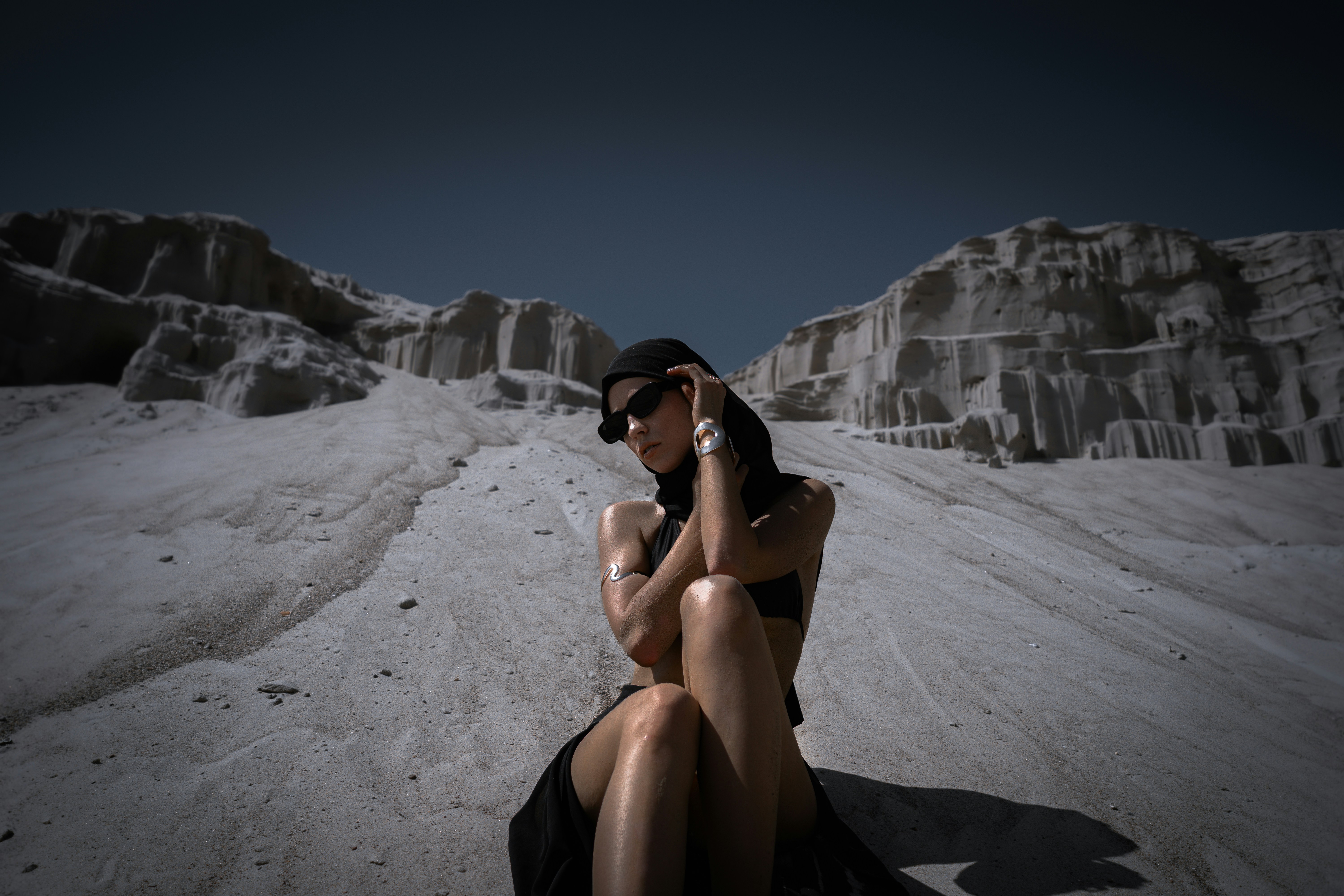 Woman posing in a desolate, rocky landscape