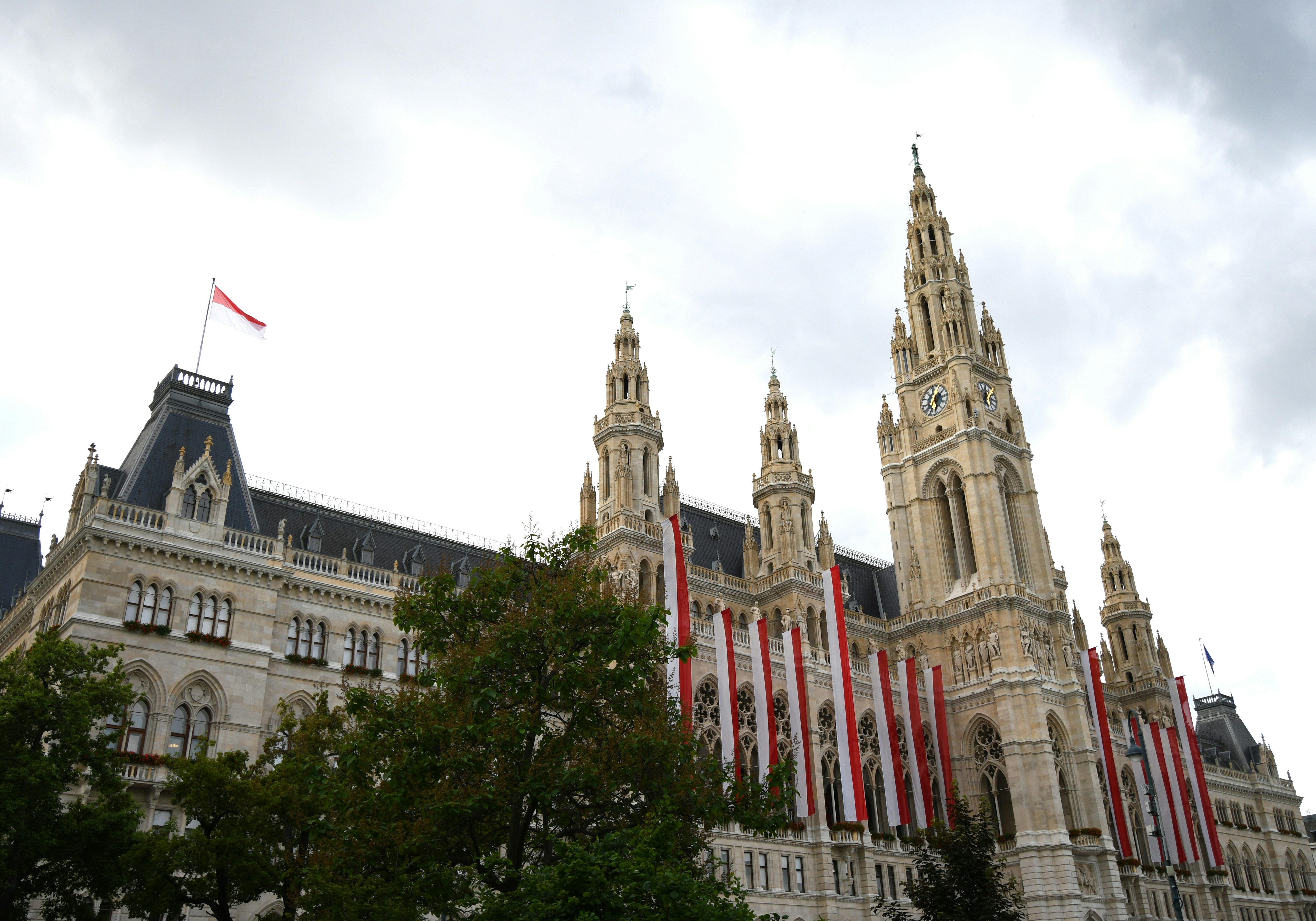 Ornate building with tall spires and austrian flags