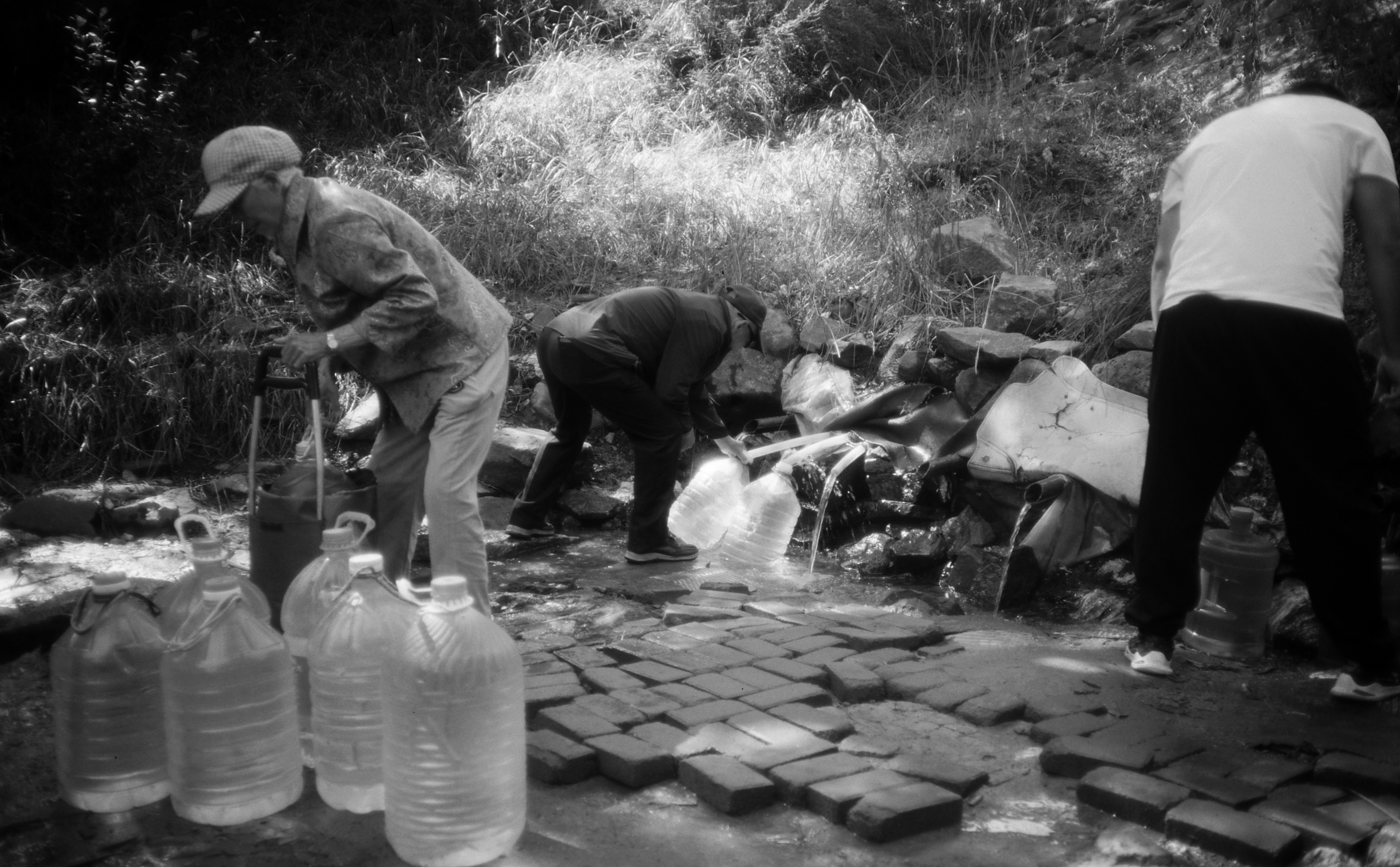 Local workers engaged in stone collection at the Jaflong river