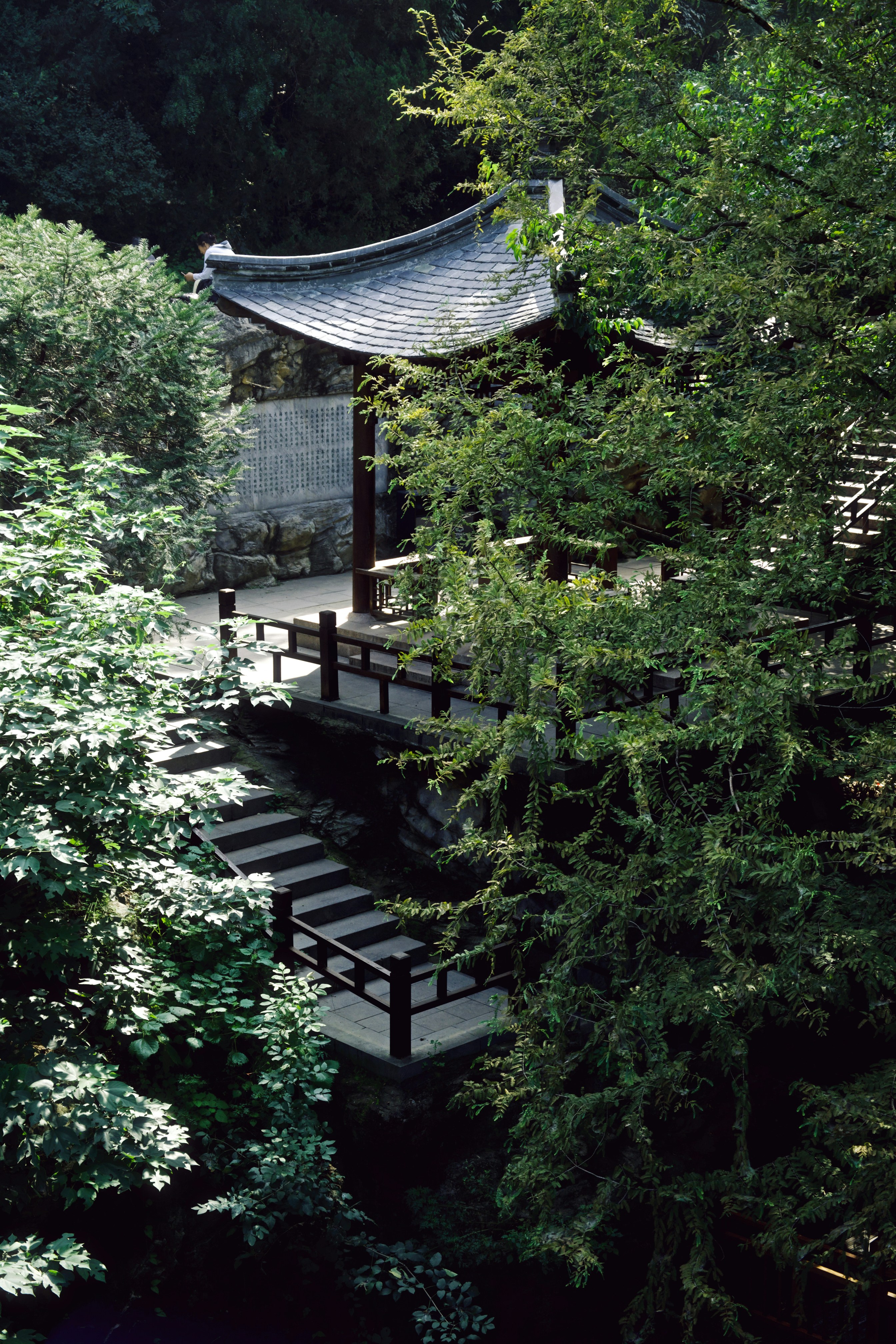 Traditional korean pavilion surrounded by lush green trees