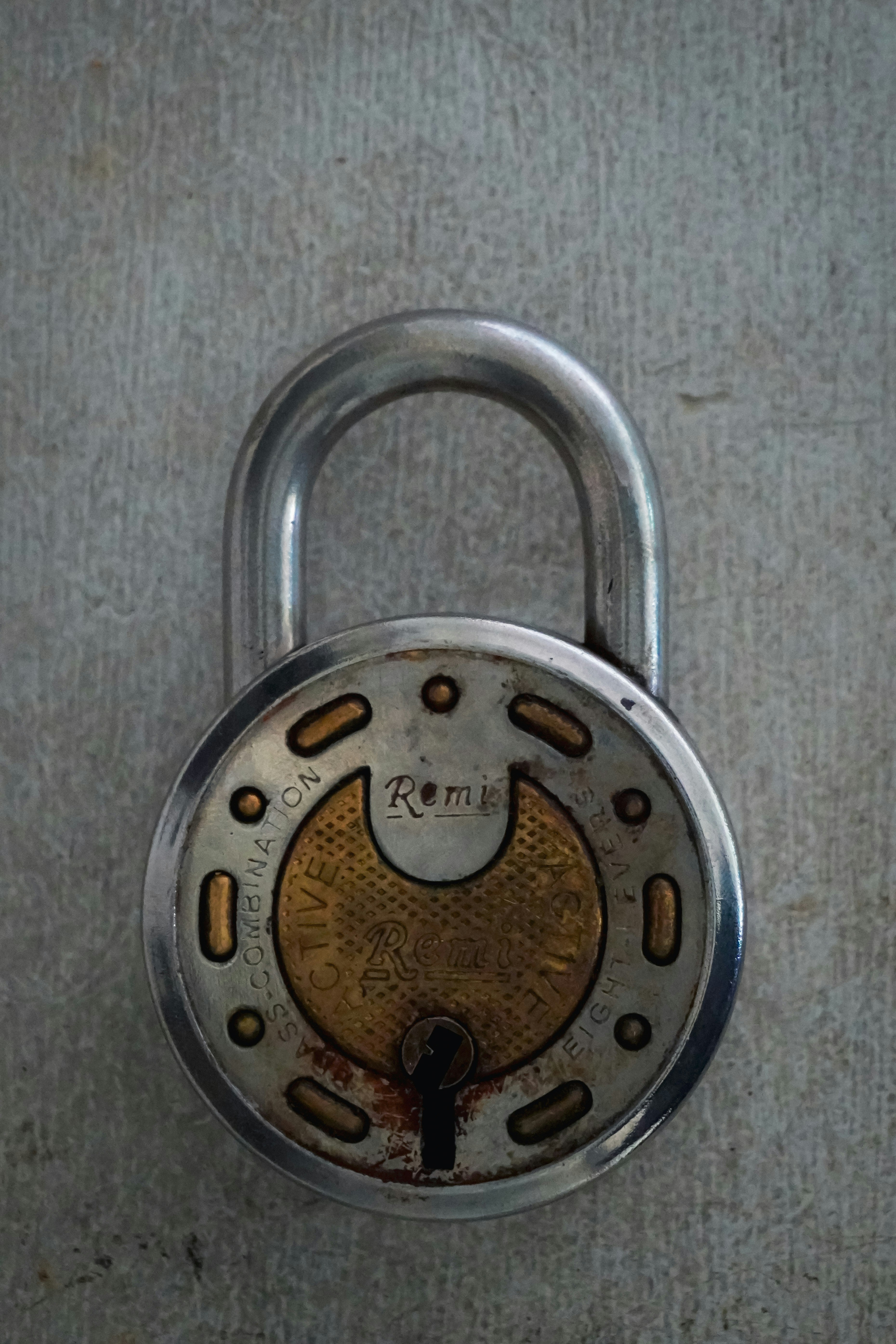 Vintage metal padlock with brass inlay detail