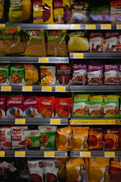Shelves stocked with various spice and food packets