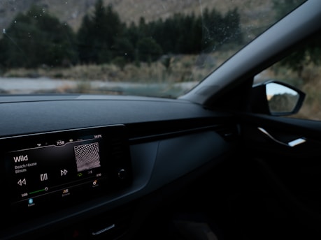 Car dashboard with music playing and view outside