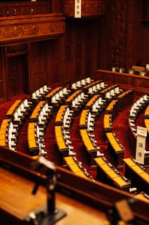 Empty parliamentary chamber with rows of seating