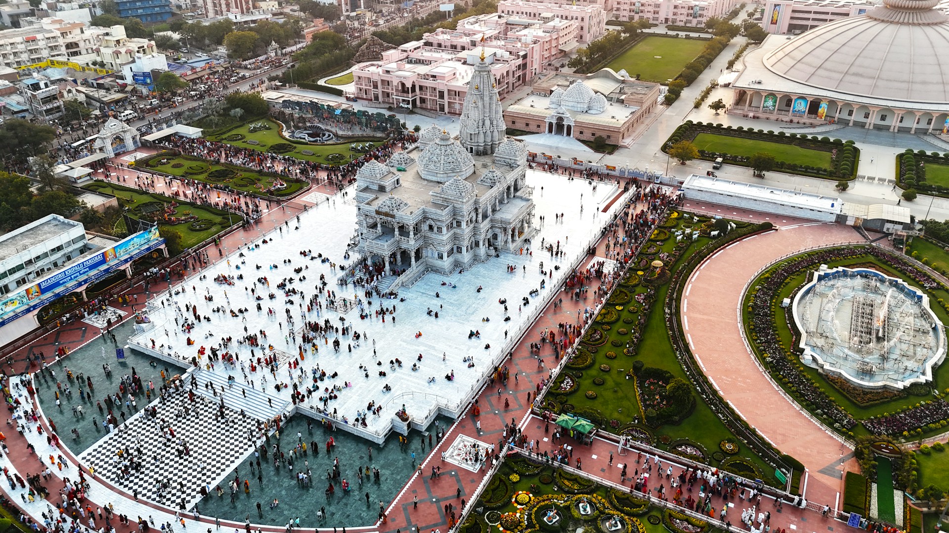 Crowded temple complex with intricate architecture and gardens