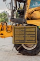Yellow combine harvester with informational sign