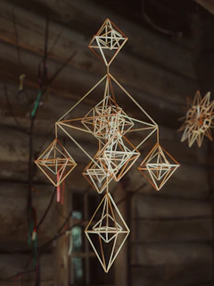 Geometric straw ornaments hanging indoors