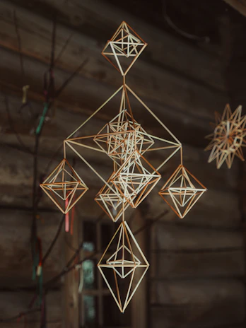 Geometric straw ornaments hanging indoors