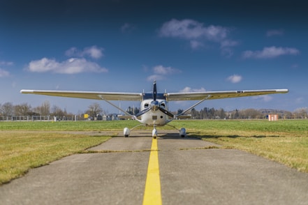 Small airplane on a runway under a blue sky