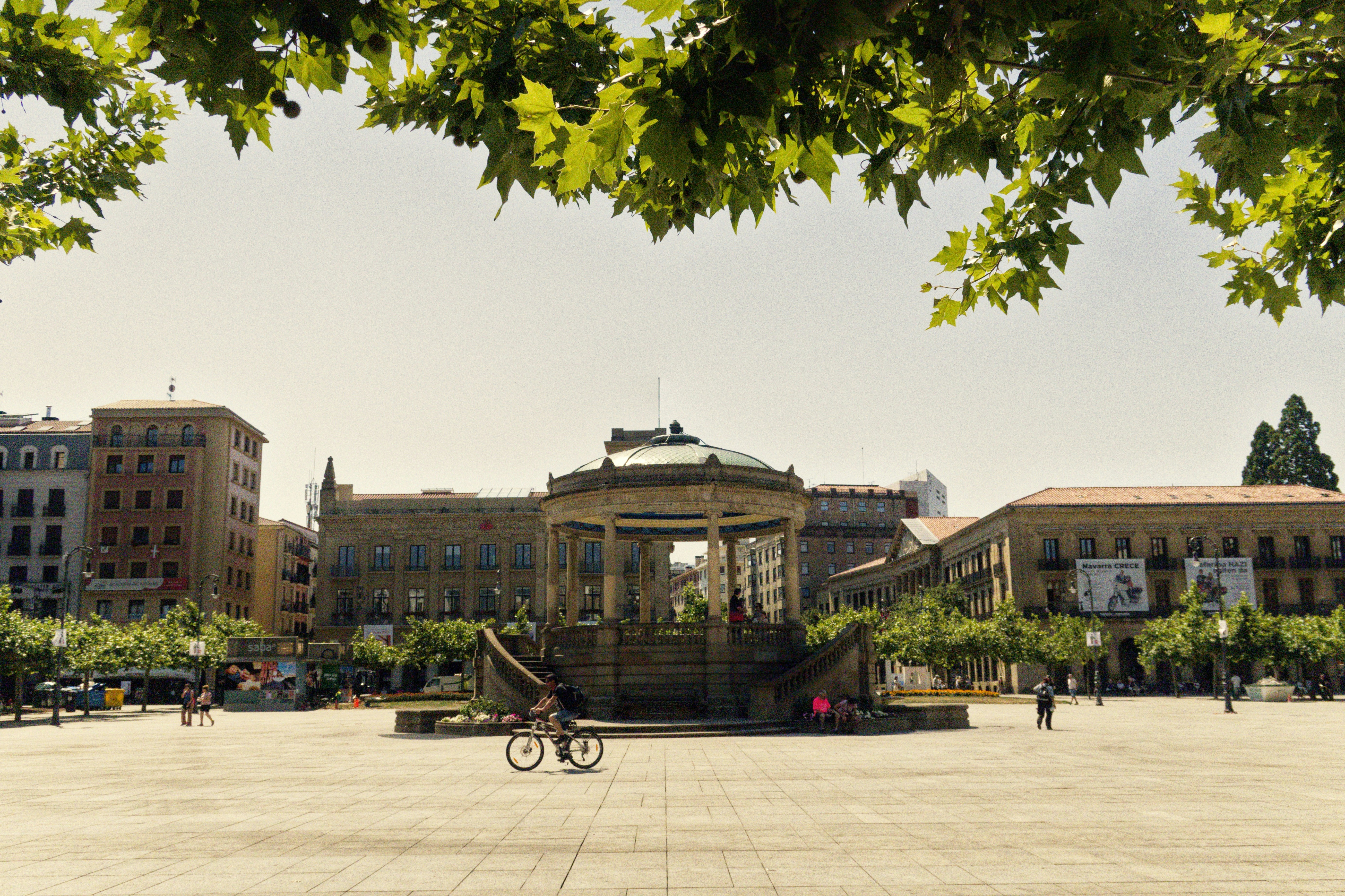 Open plaza with a bandstand and surrounding buildings.