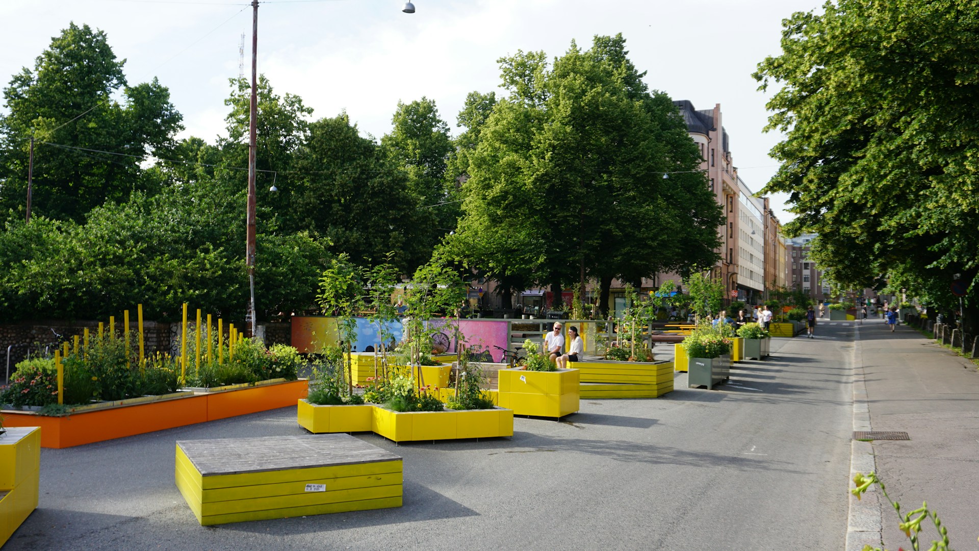 Urban street with colorful planters and trees