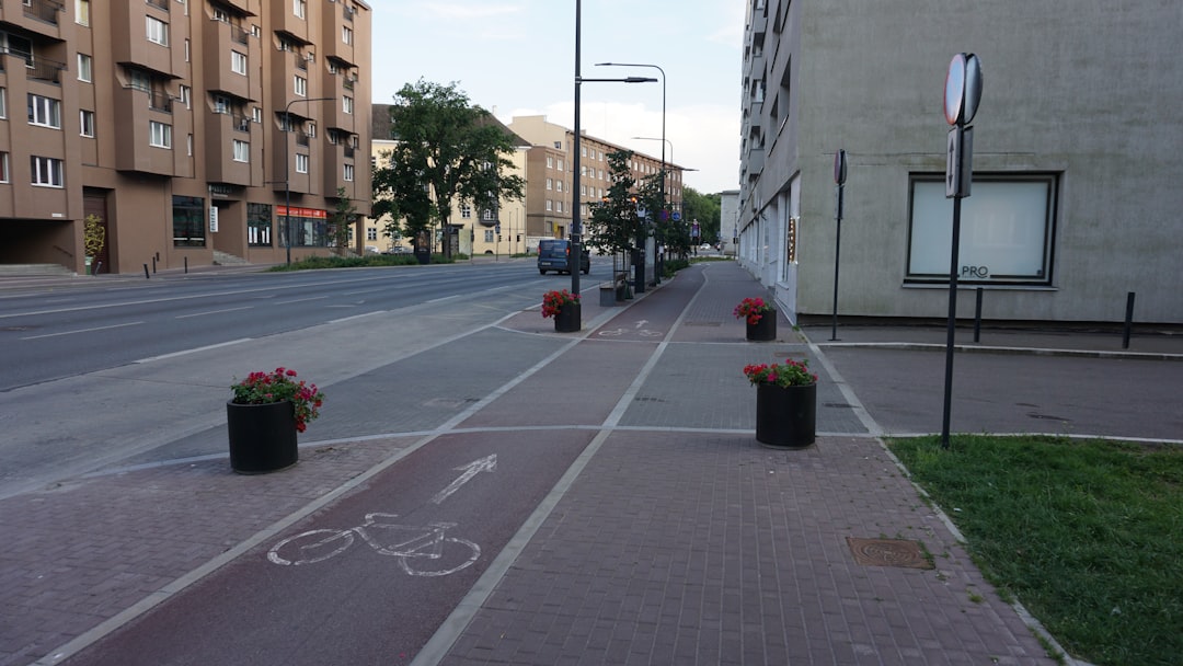 a bicycle lane next to a busy roadway in a city a bicycle lane next to a busy roadway in a city