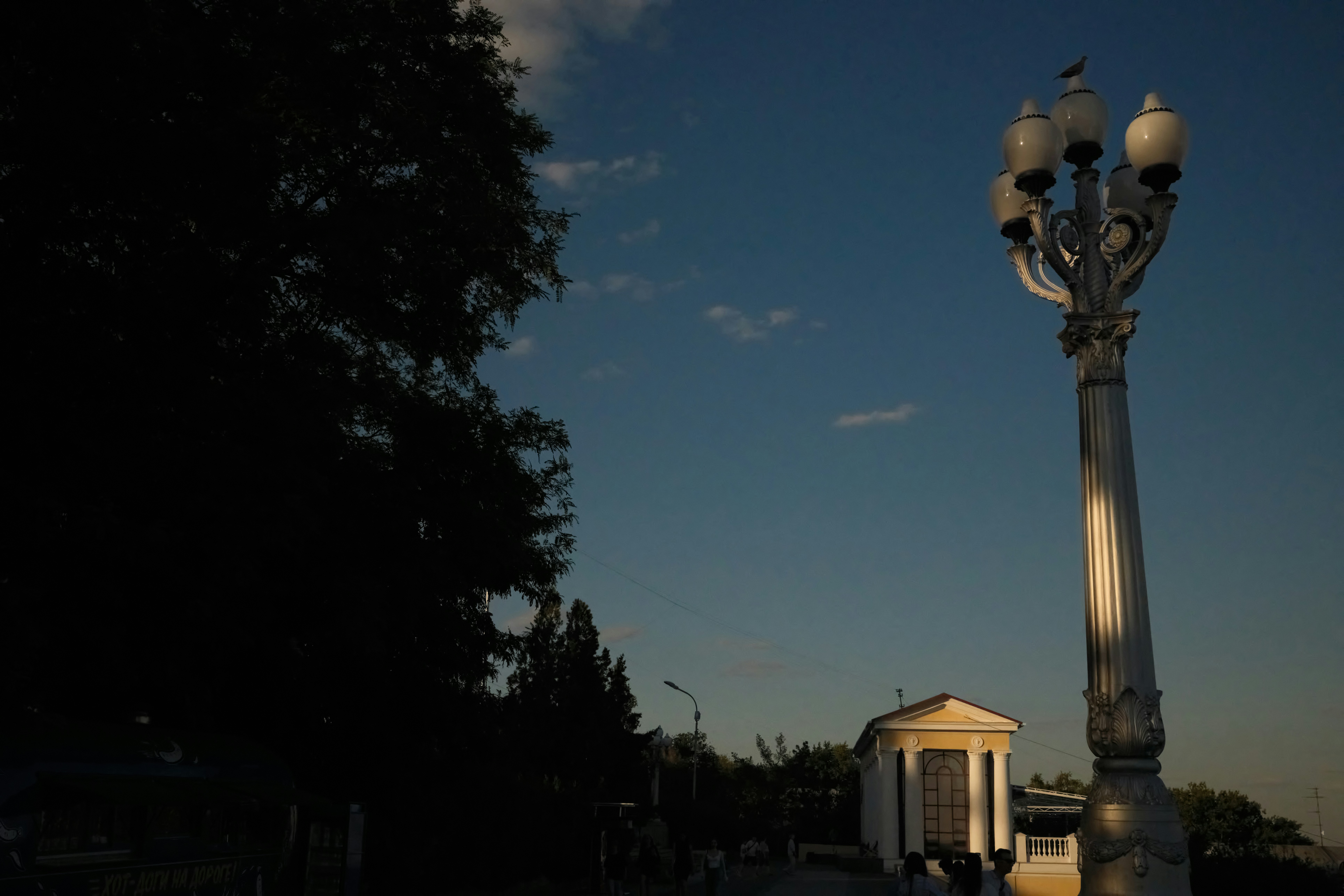 Street lamp and building against a clear sky