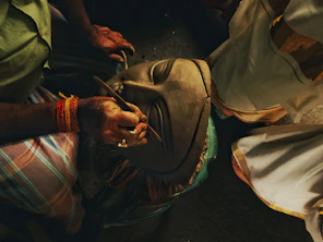 Artist meticulously crafting a traditional mask