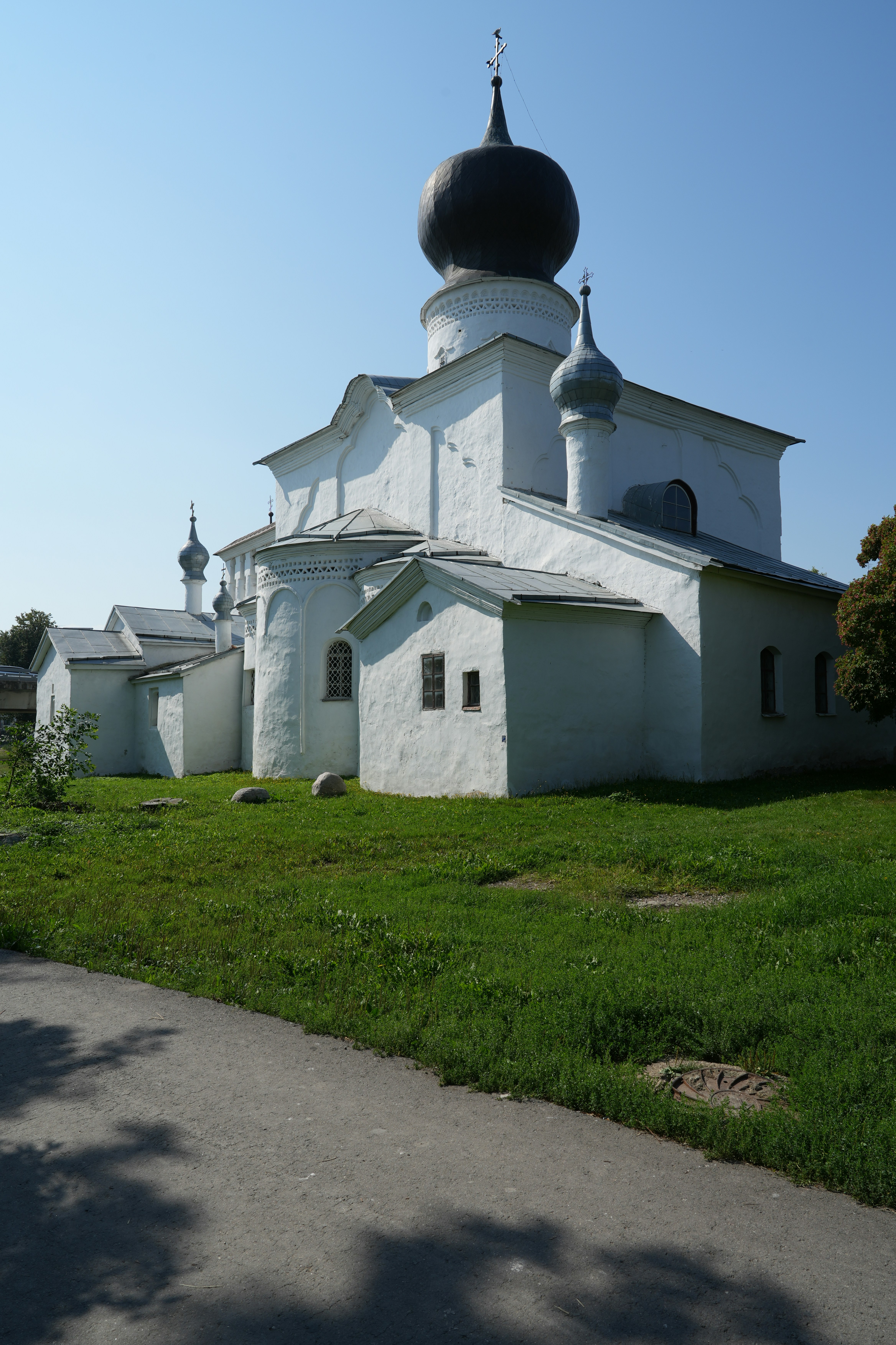 White historic church with a large dark dome.