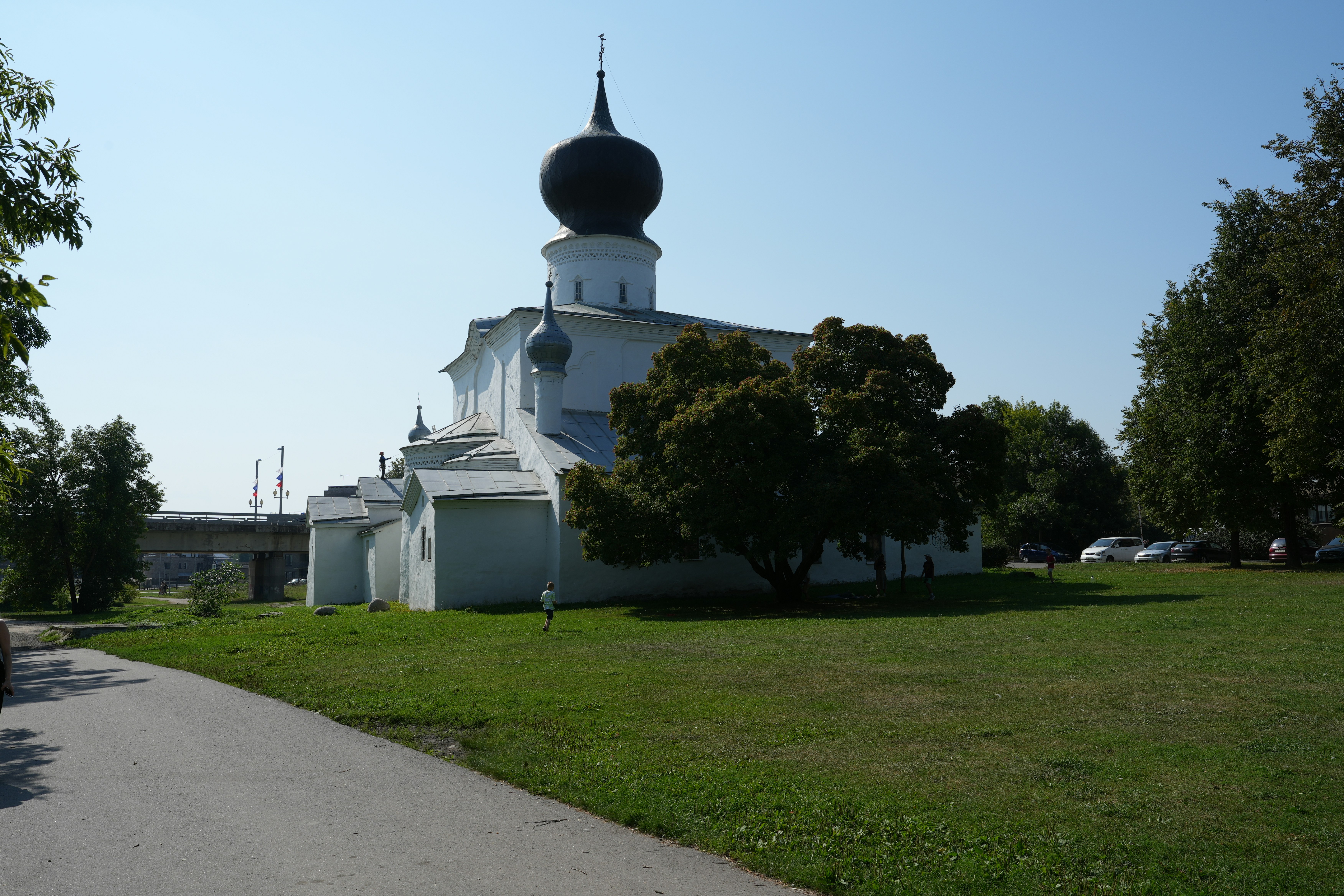 White church with black dome and green grass