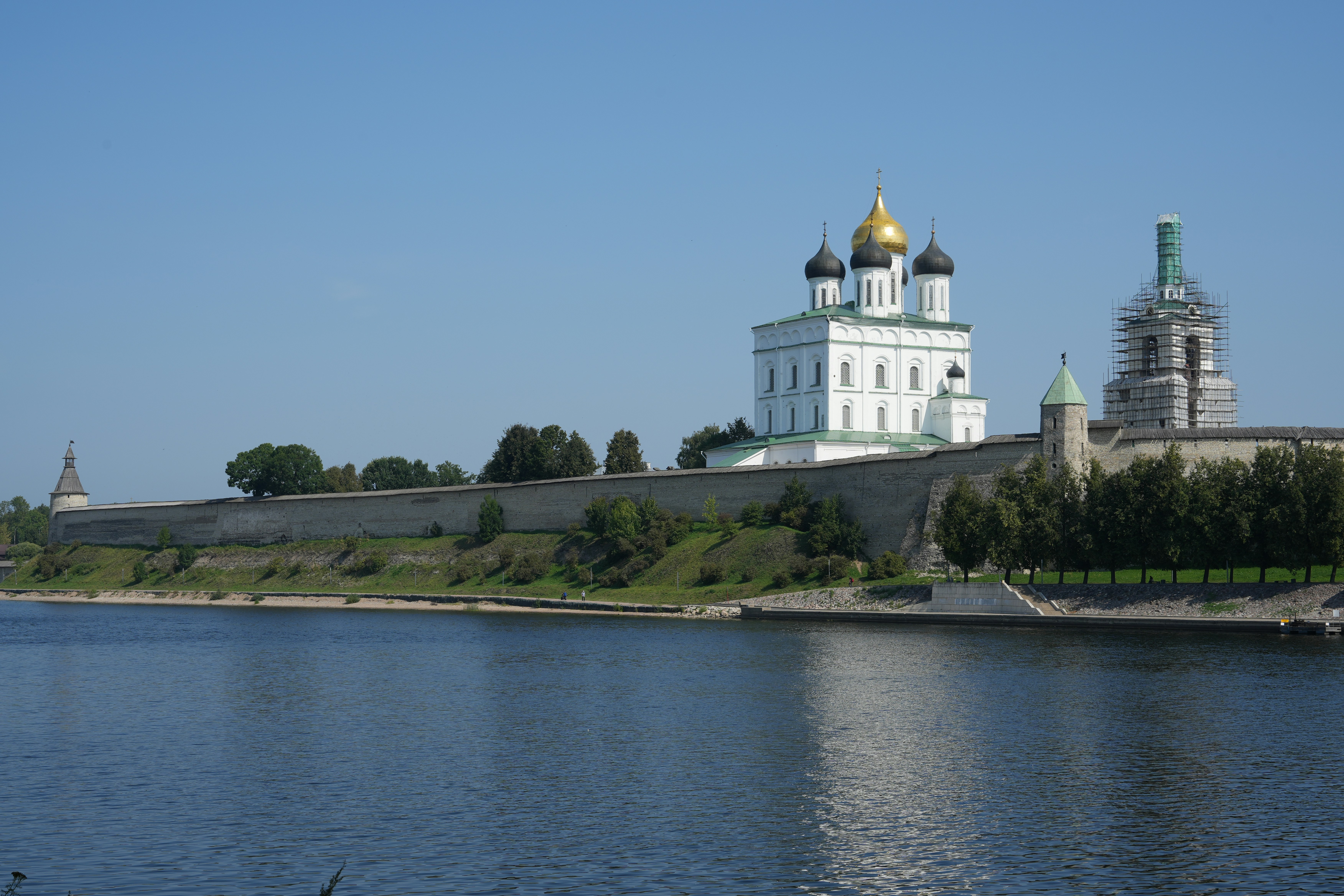 Historic fortress walls and white cathedral by river