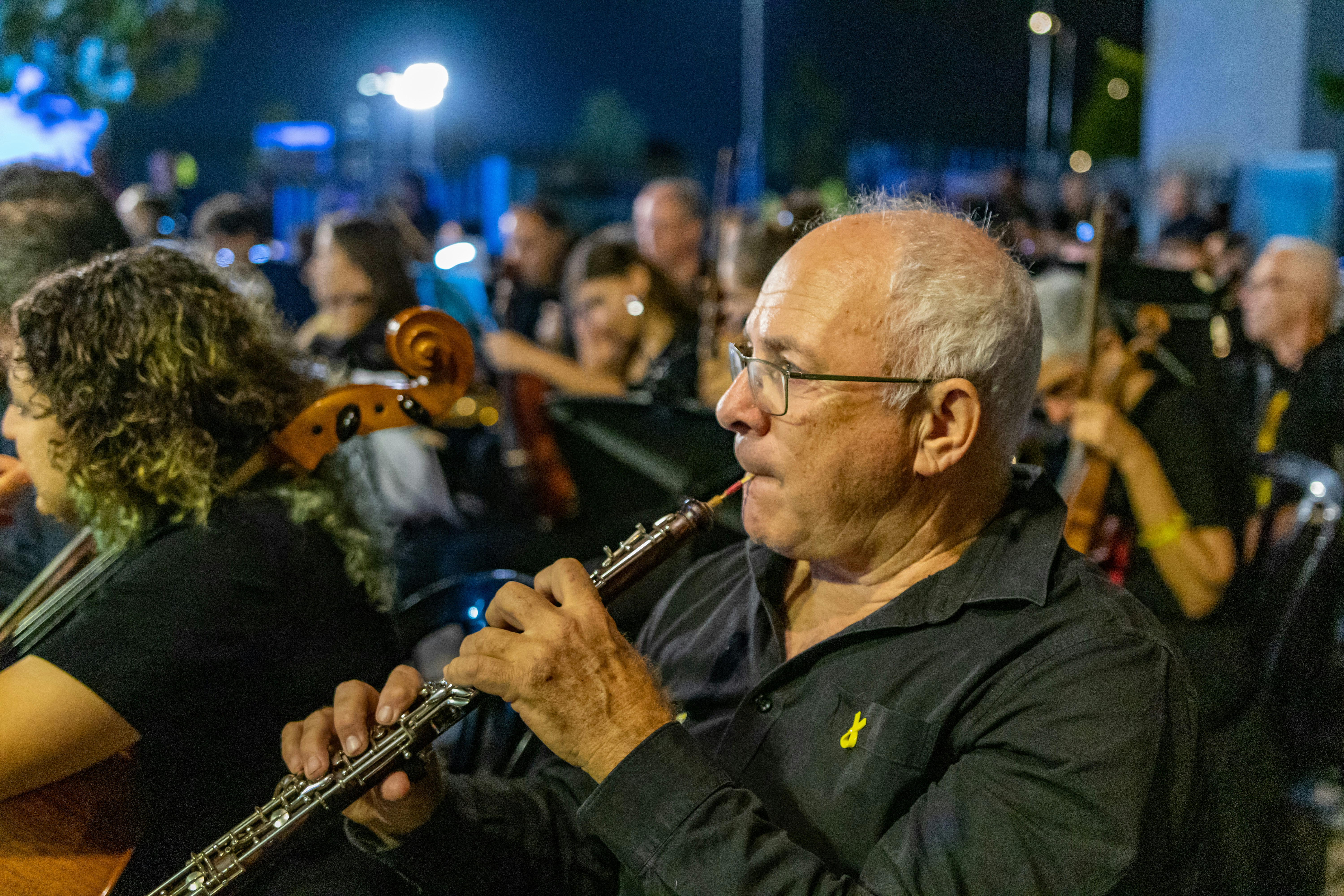 Man playing oboe in orchestra