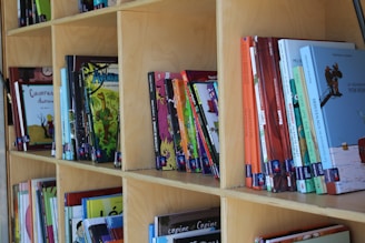Books arranged on wooden shelves in a library