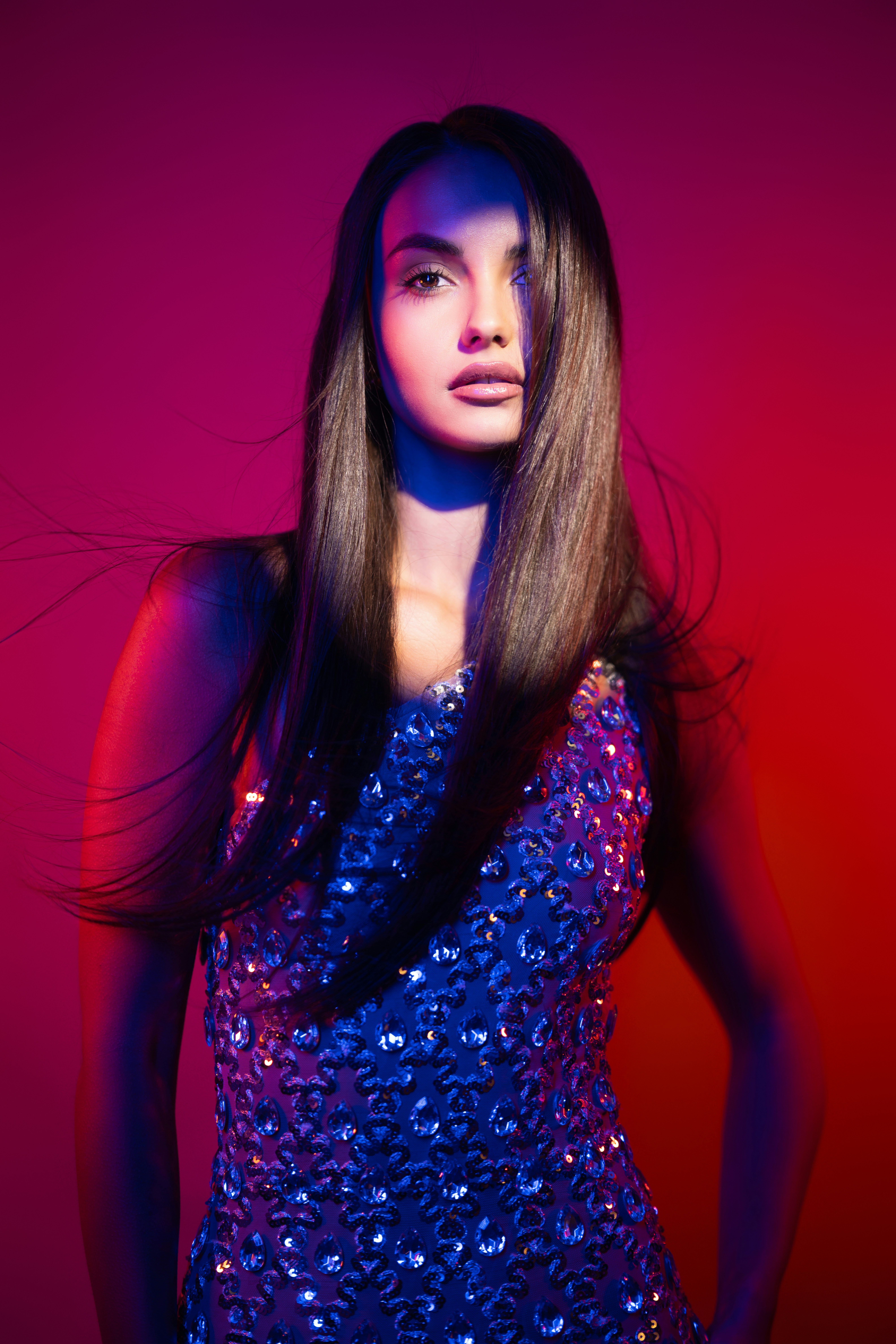 Woman in sequined dress with dramatic lighting