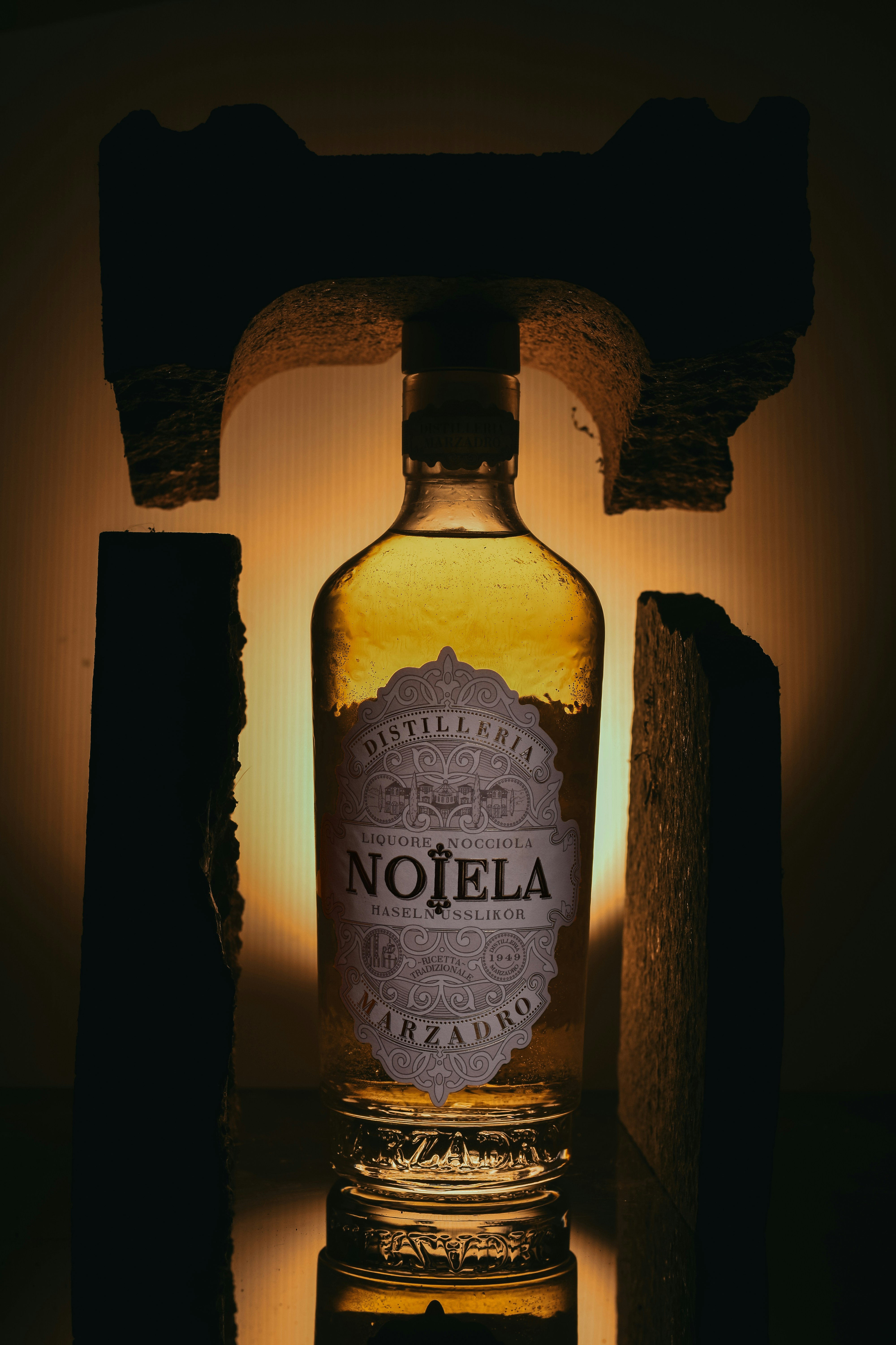 Bottle of nojela liqueur illuminated dramatically