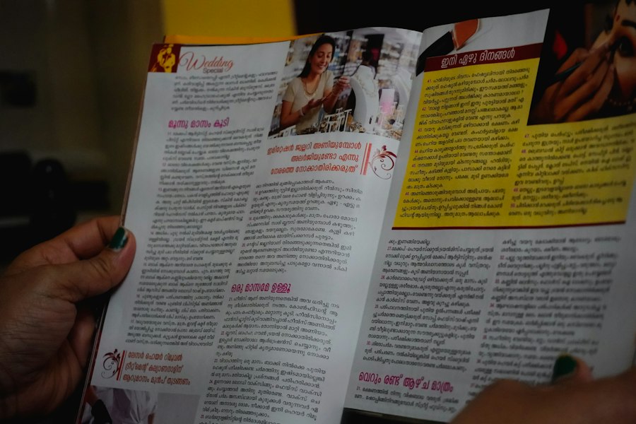 Hands holding an open brochure spread full of text and photos