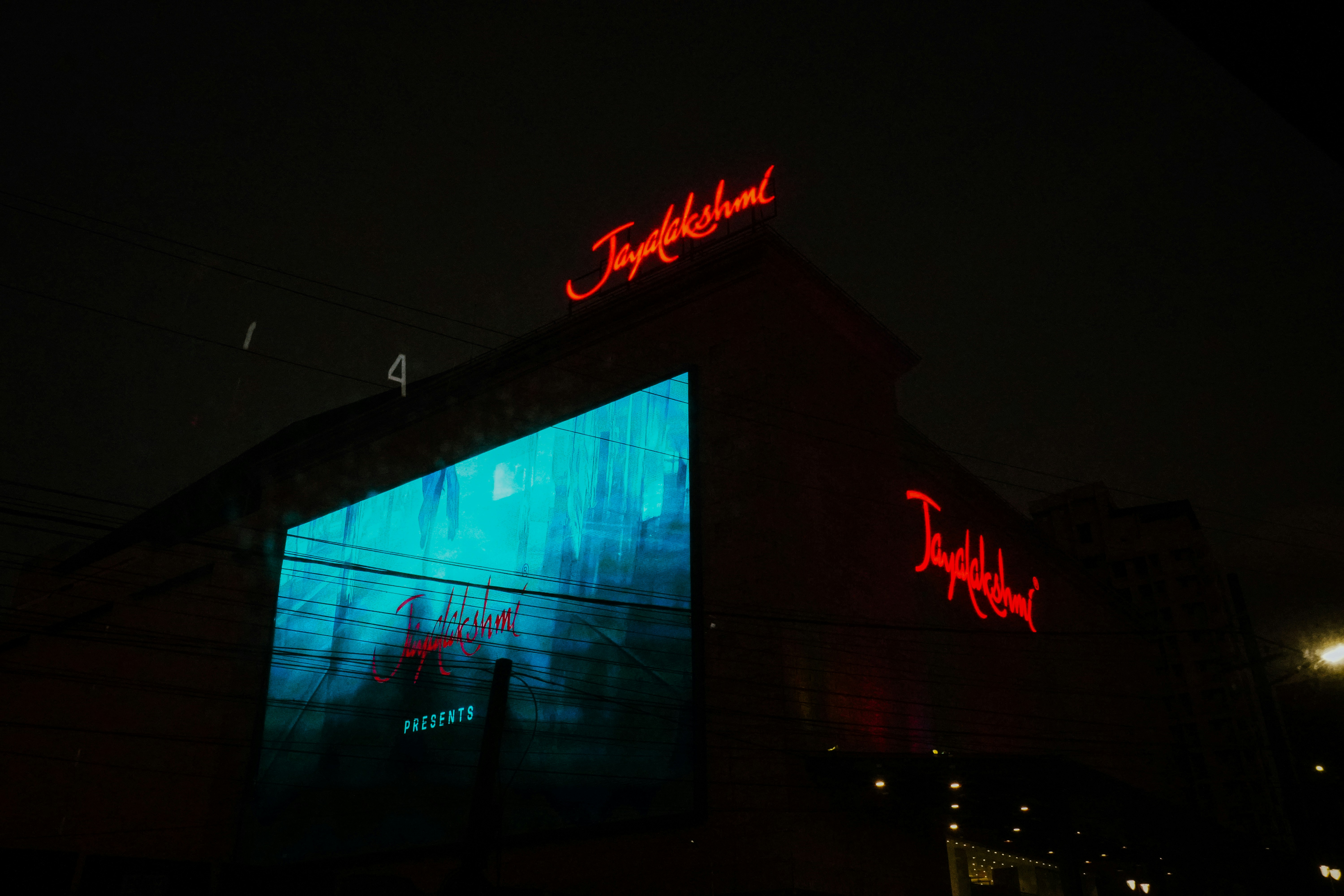 Building with neon "tivoli" sign at night