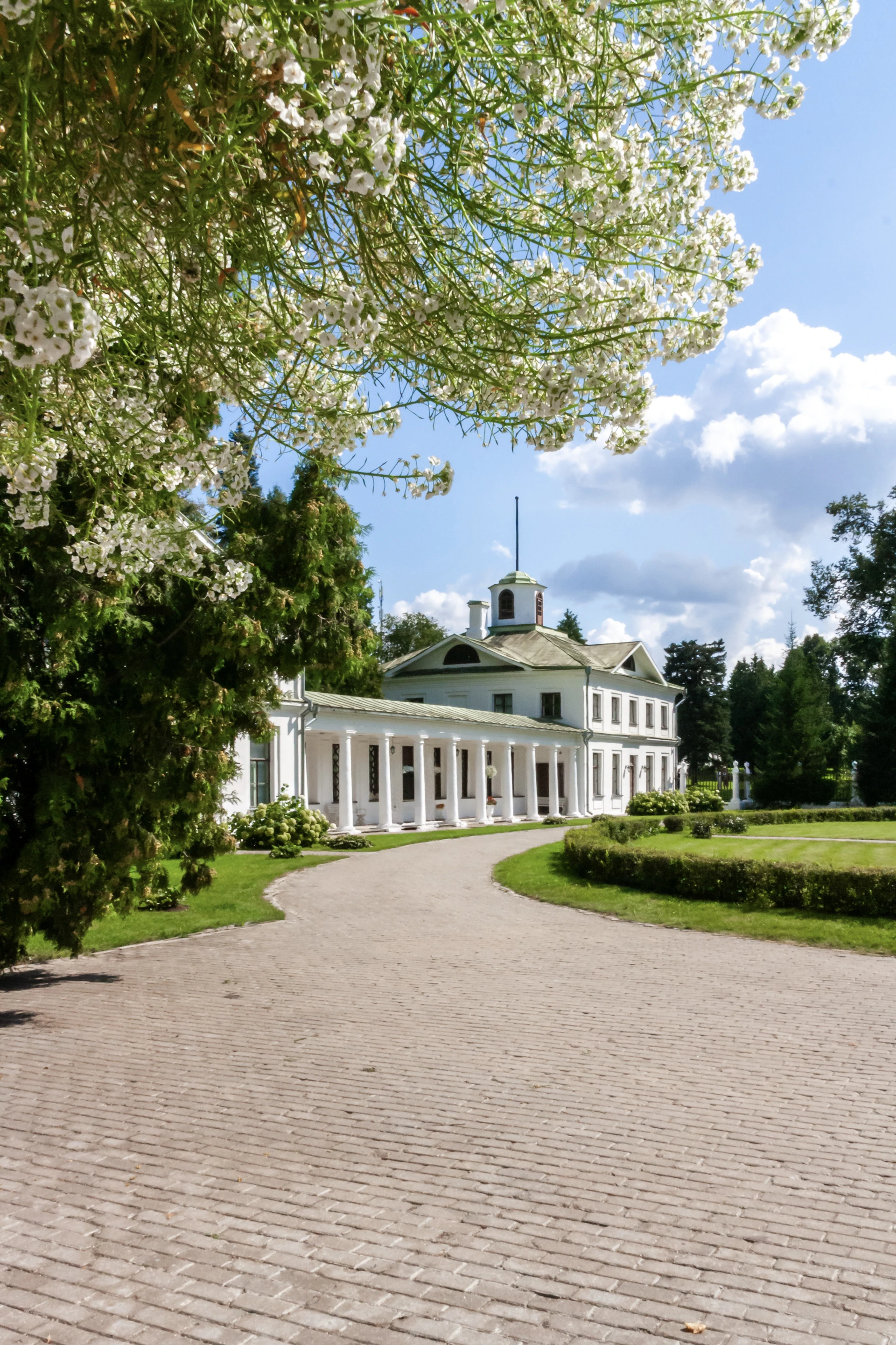 White neoclassical mansion with a long colonnade
