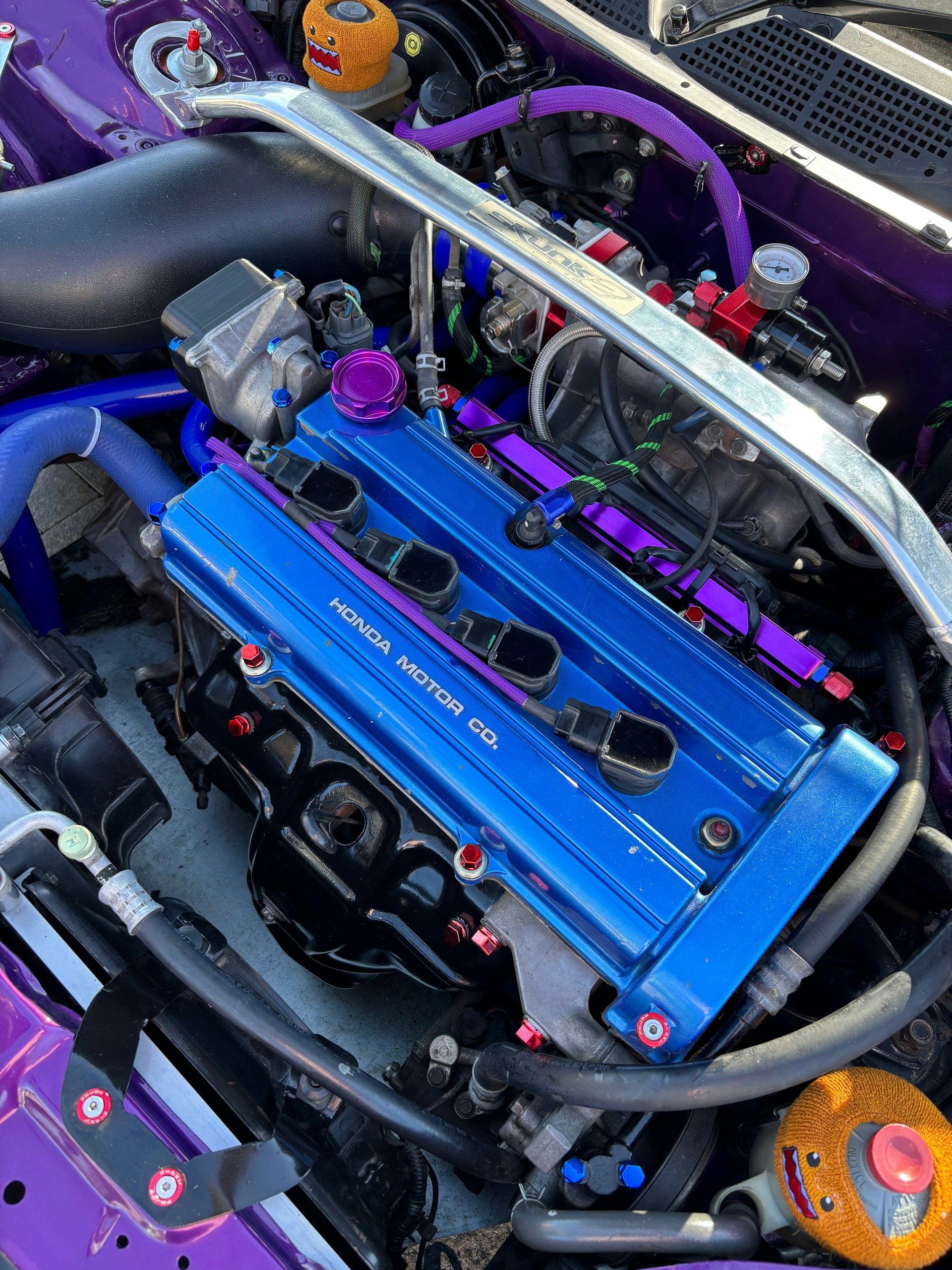 Customized blue honda engine with purple accents