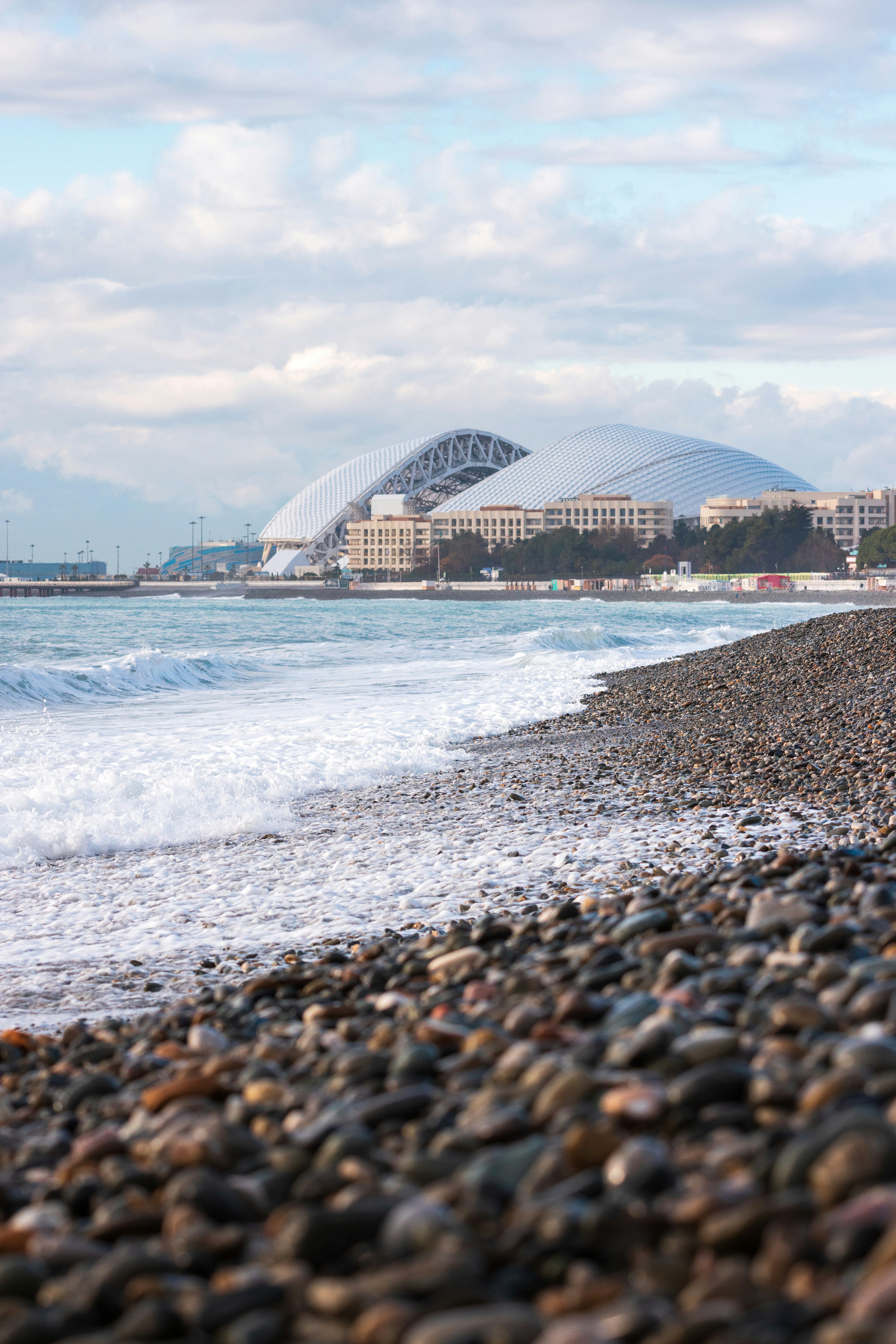 Pebble beach with stadium and ocean waves