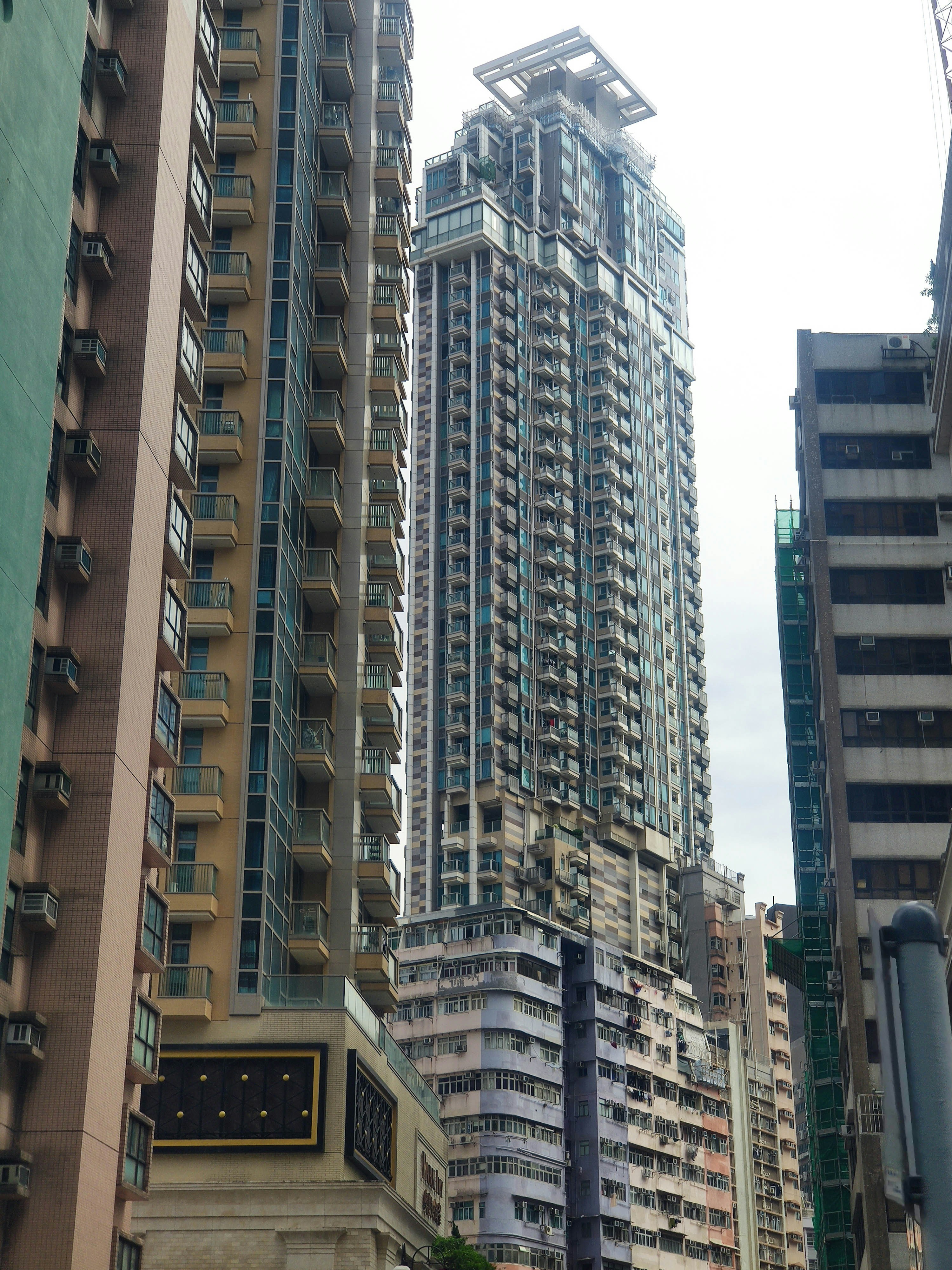 Tall modern skyscrapers and older buildings in a city.