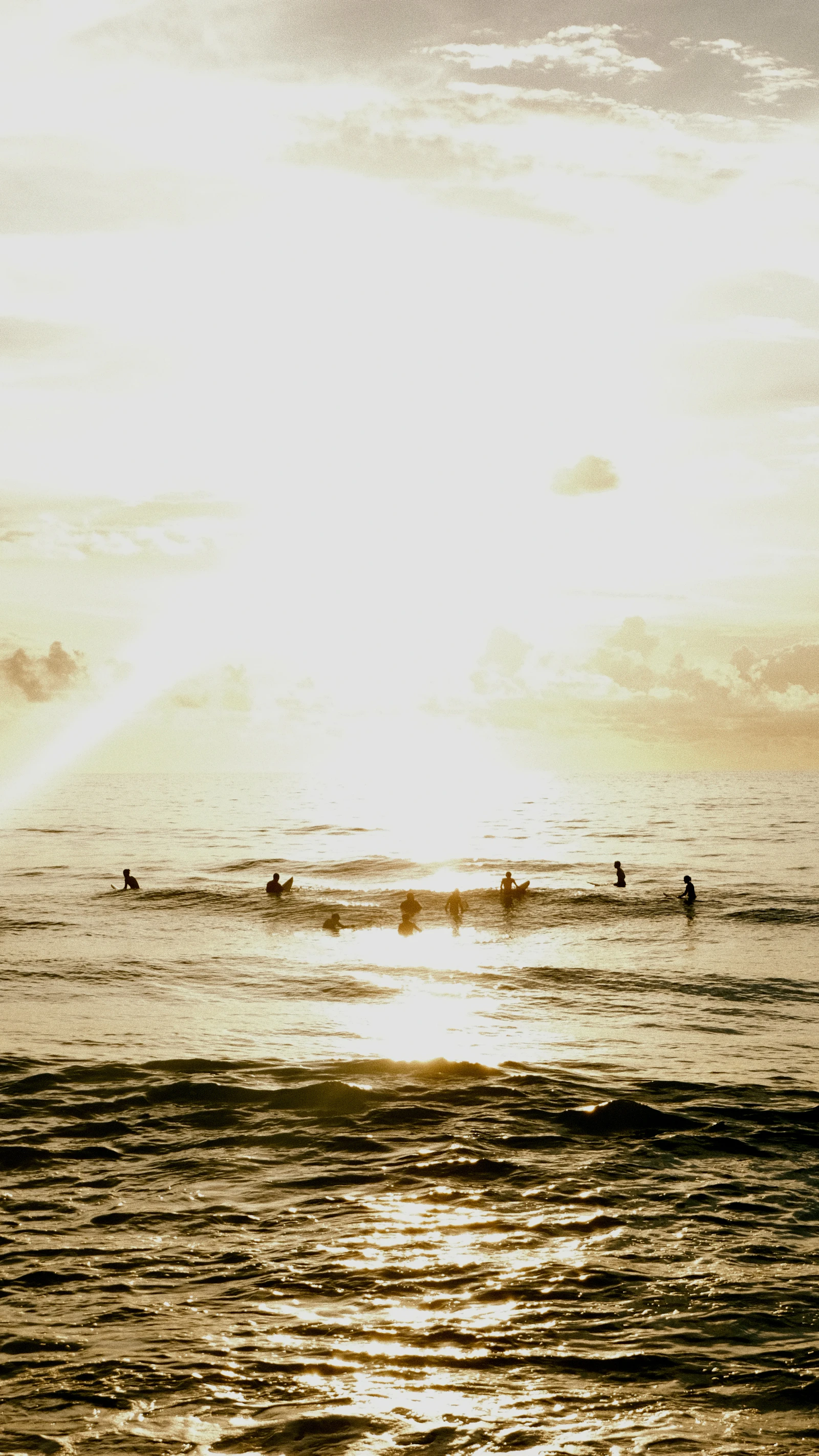 Surfers waiting for waves at sunrise off Sayulita, Mexico