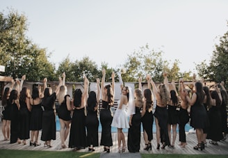 Bride and bridesmaids celebrating with raised arms