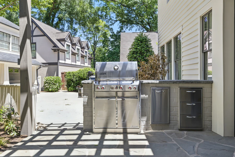 A premium built-in propane grill on a stone patio