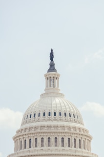 United states capitol building dome against a pale sky