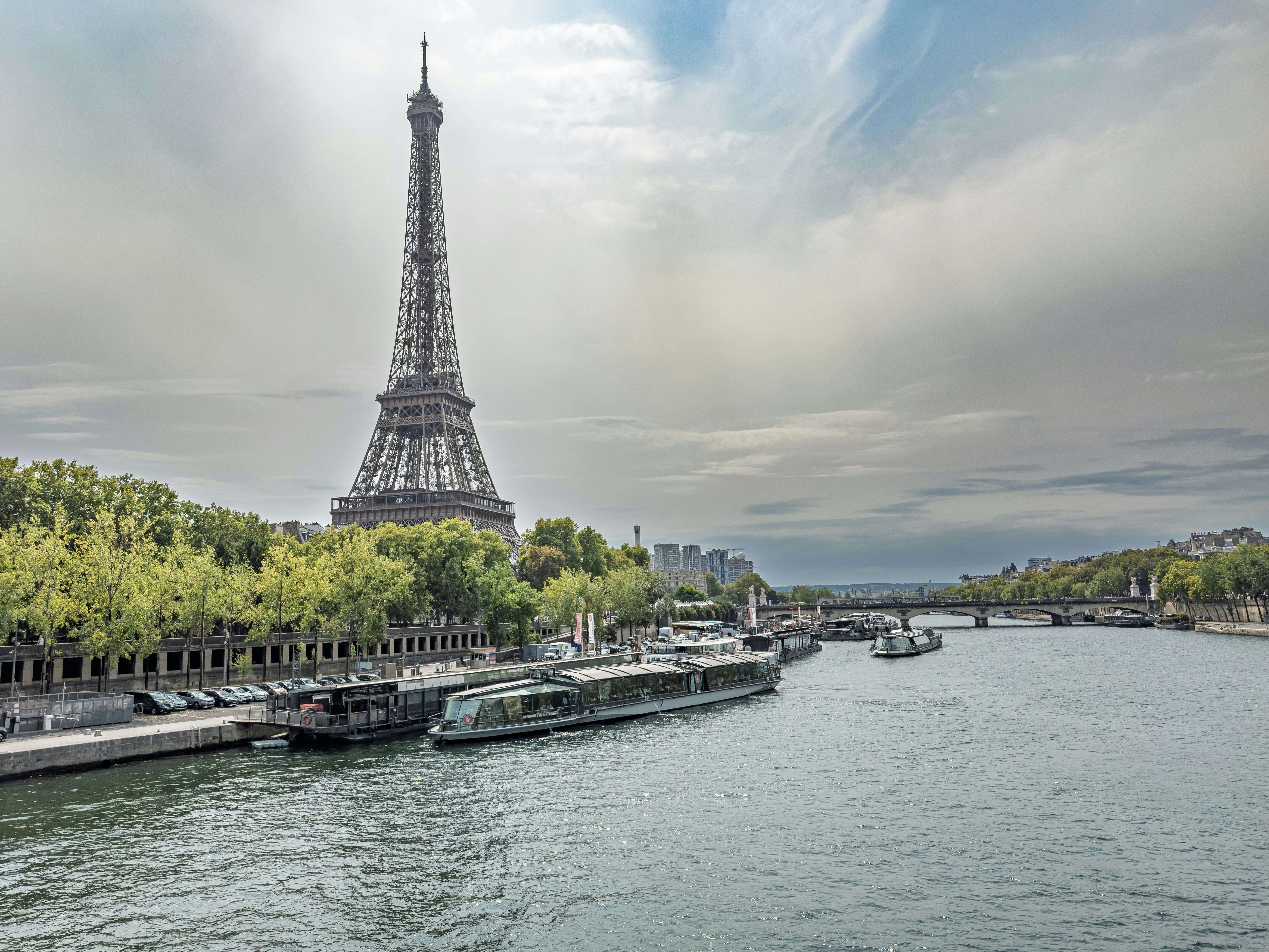 Eiffel tower and seine river with boats in paris