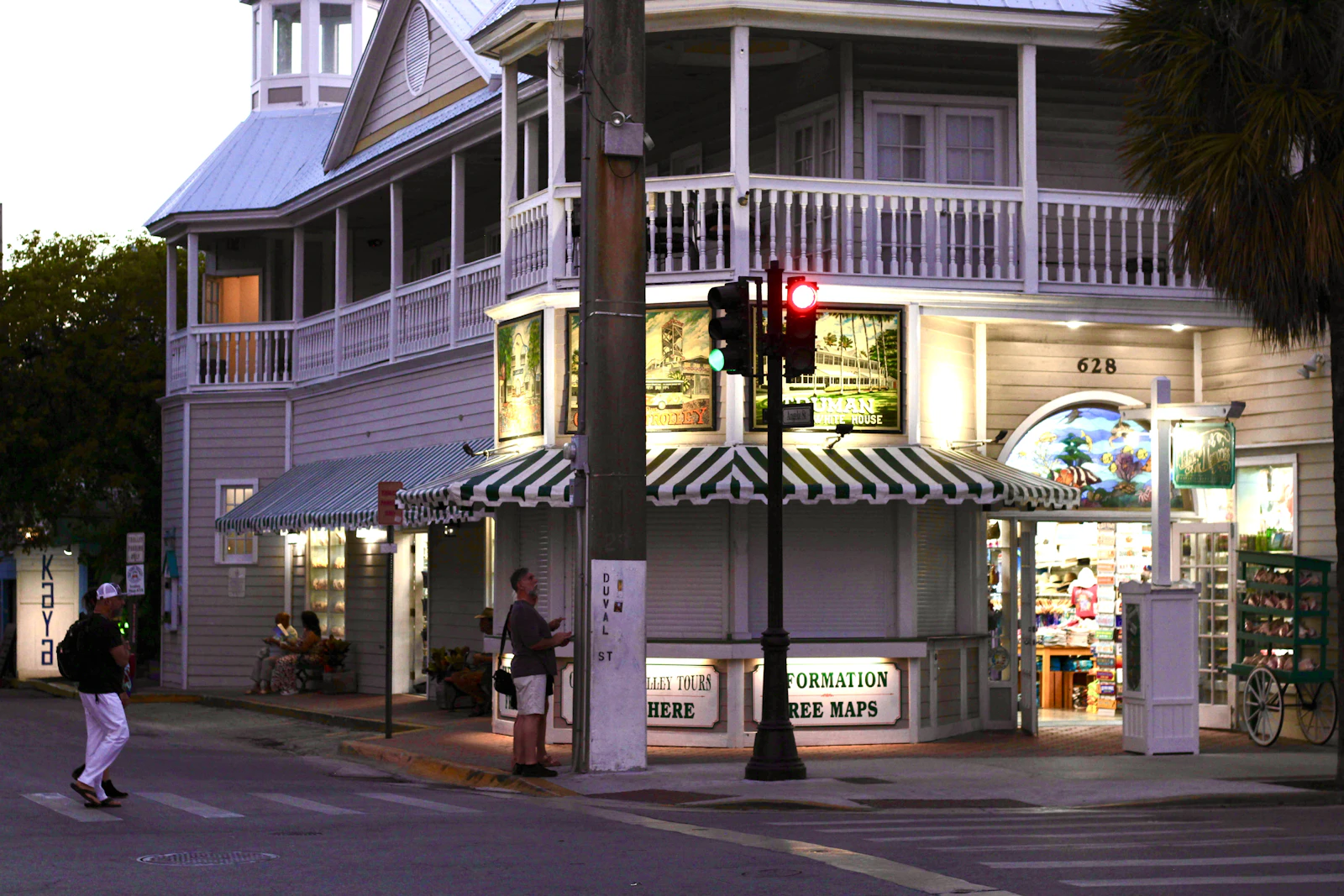 A corner building of shops and awnings at dusk in Key West