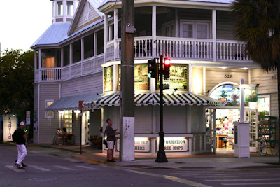 A corner building of shops and awnings at dusk in Key West