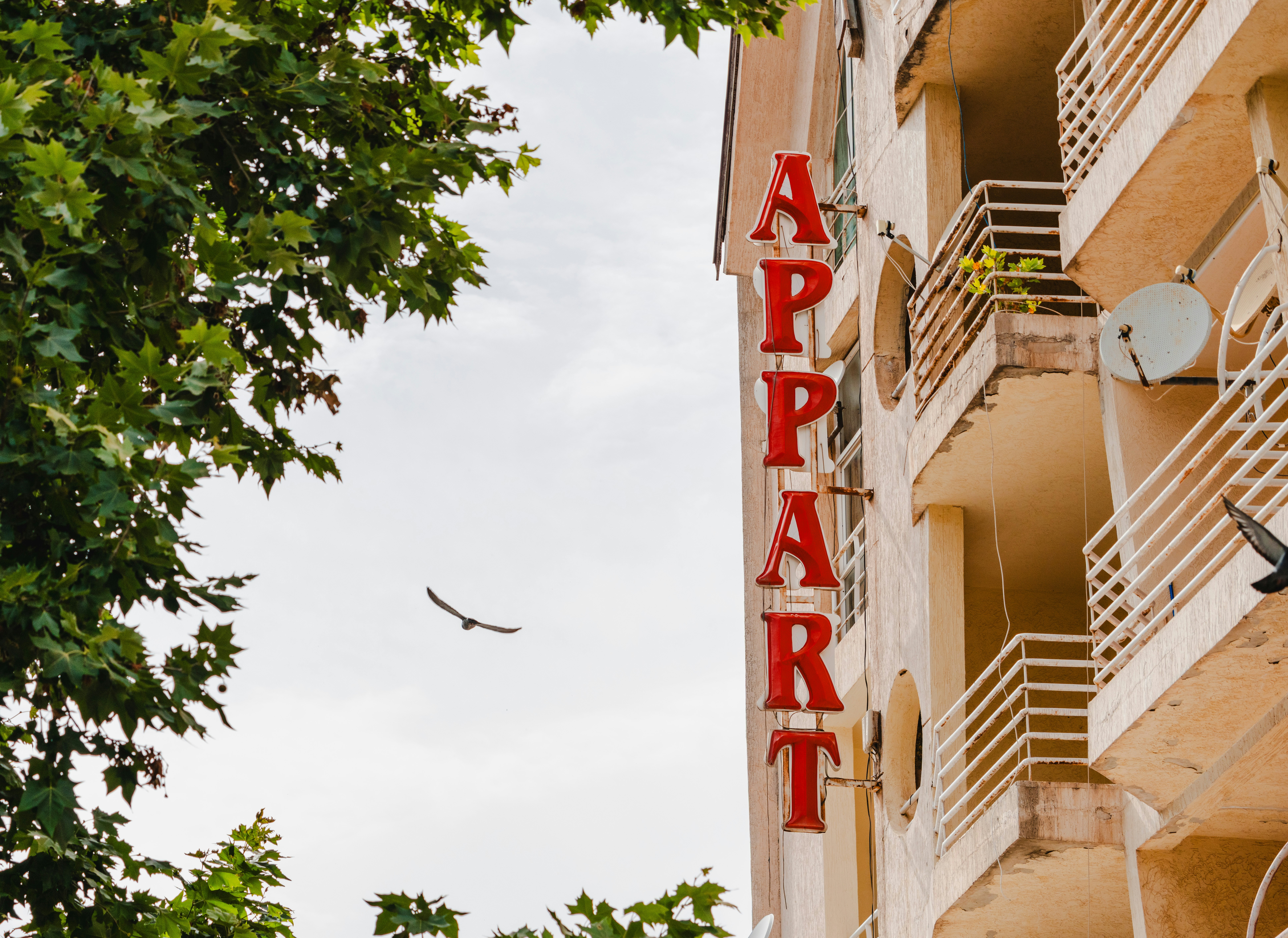 Apartment building with red sign