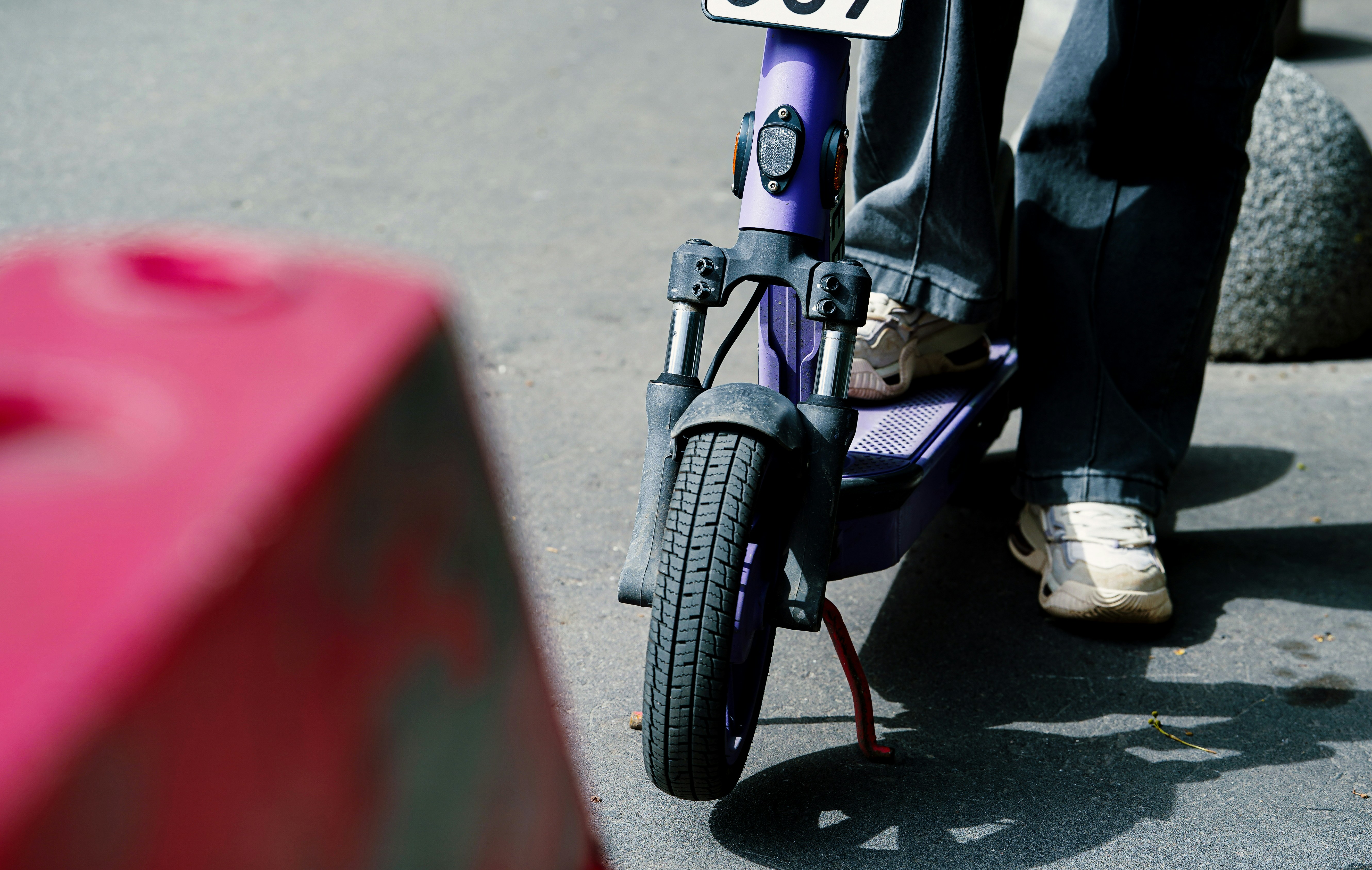 Person riding an electric scooter on a sunny day