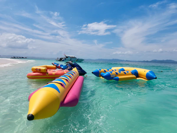 Inflatable banana boats on clear turquoise water
