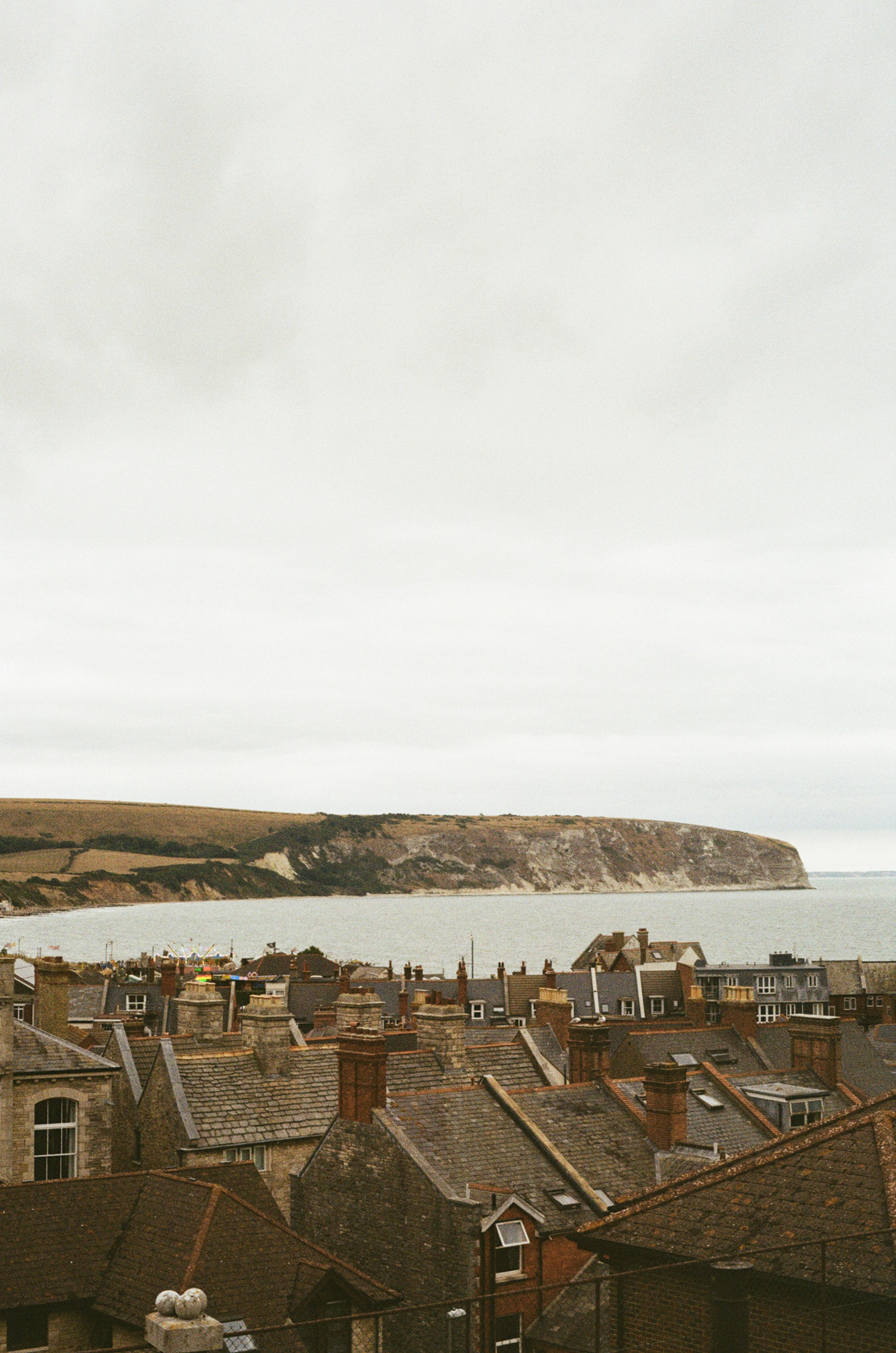 Coastal town with rooftops overlooking the sea and cliffs
