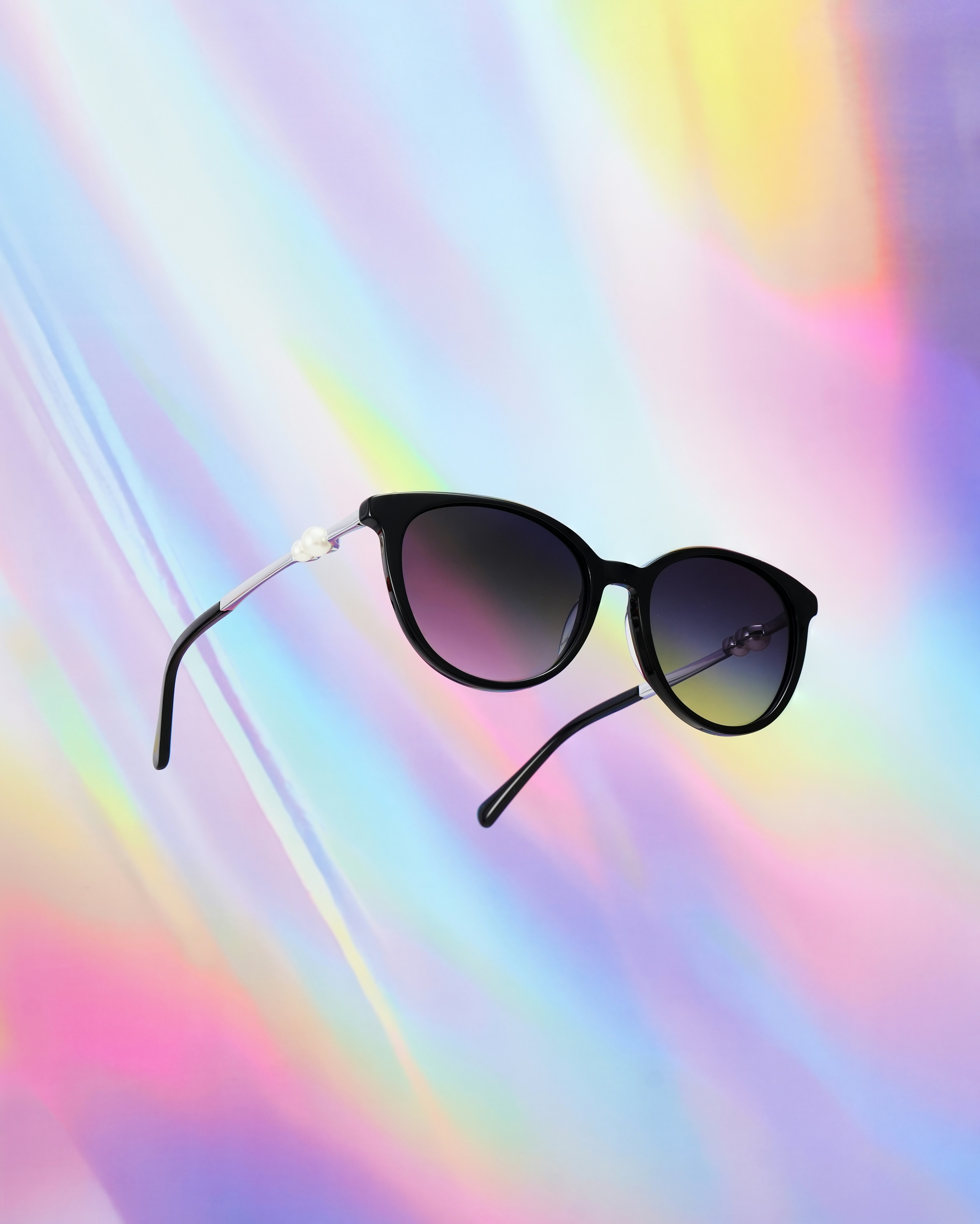 Black sunglasses with gradient lenses on colorful background