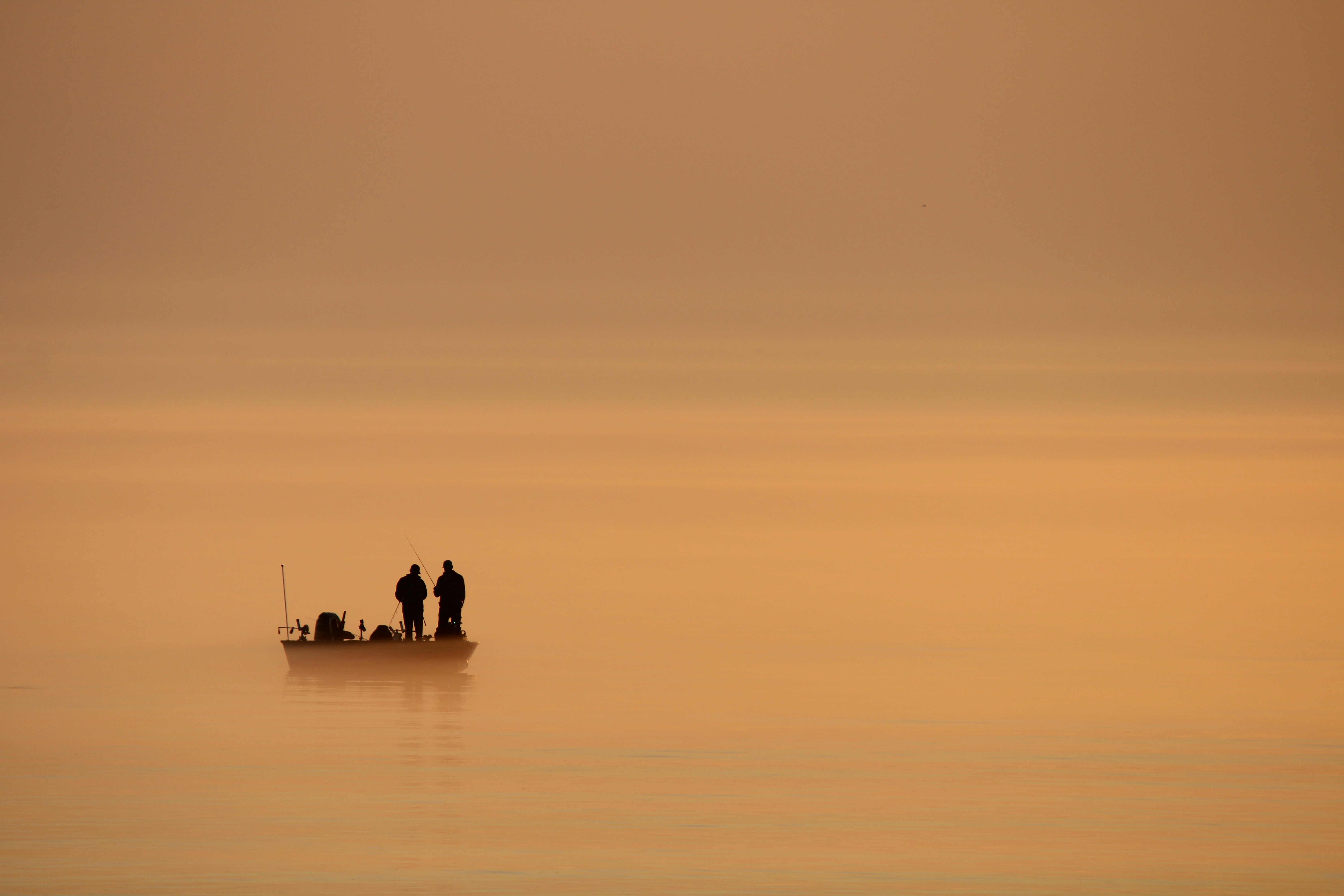Bote de pesca en un lago al amanecer, estilo visual similar al tema del juego