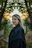 Woman with blonde hair in dark coat outdoors