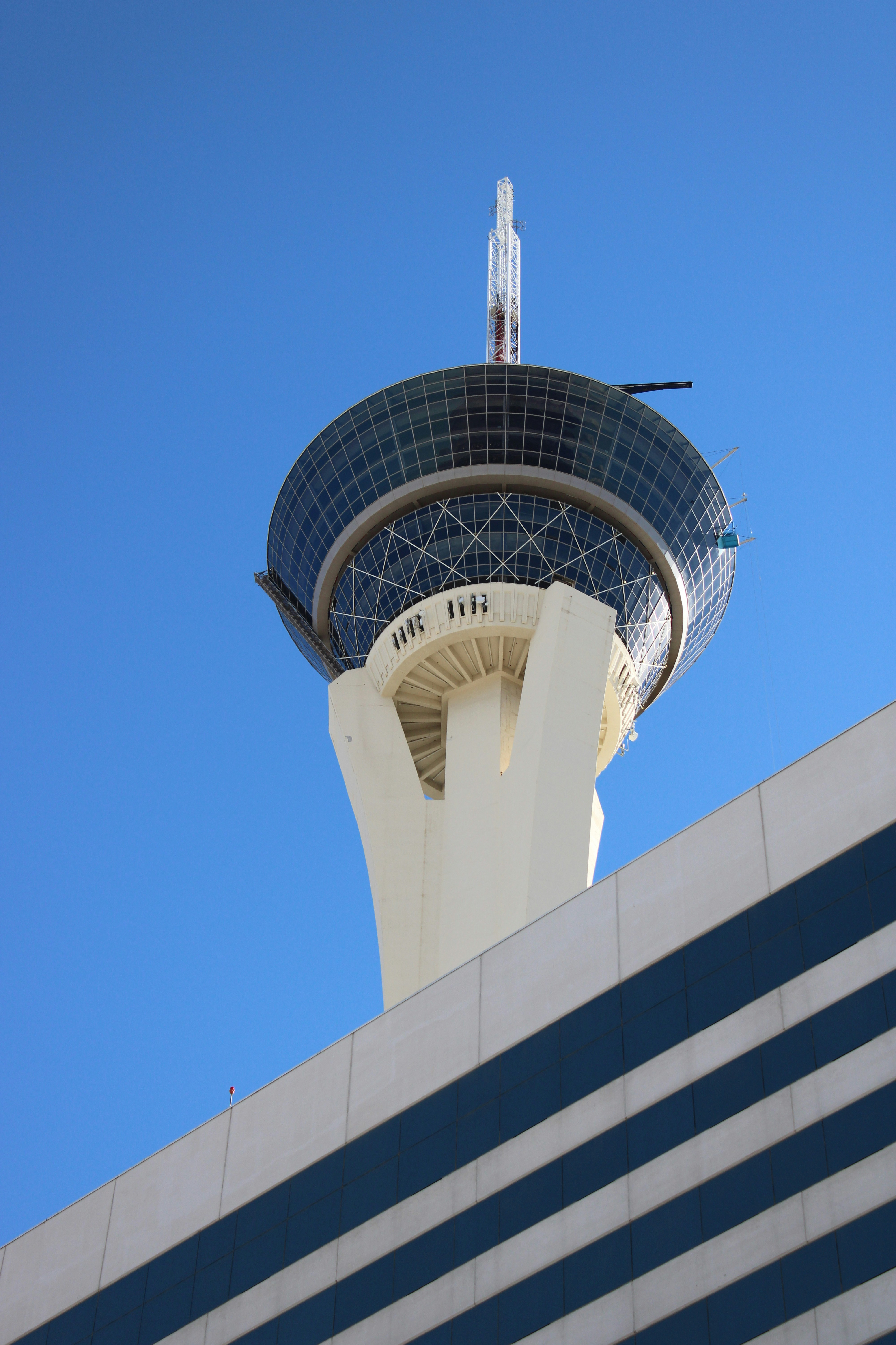 Modern skyscraper with observation deck against blue sky