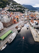 Aerial view of a harbor with boats and colorful buildings.