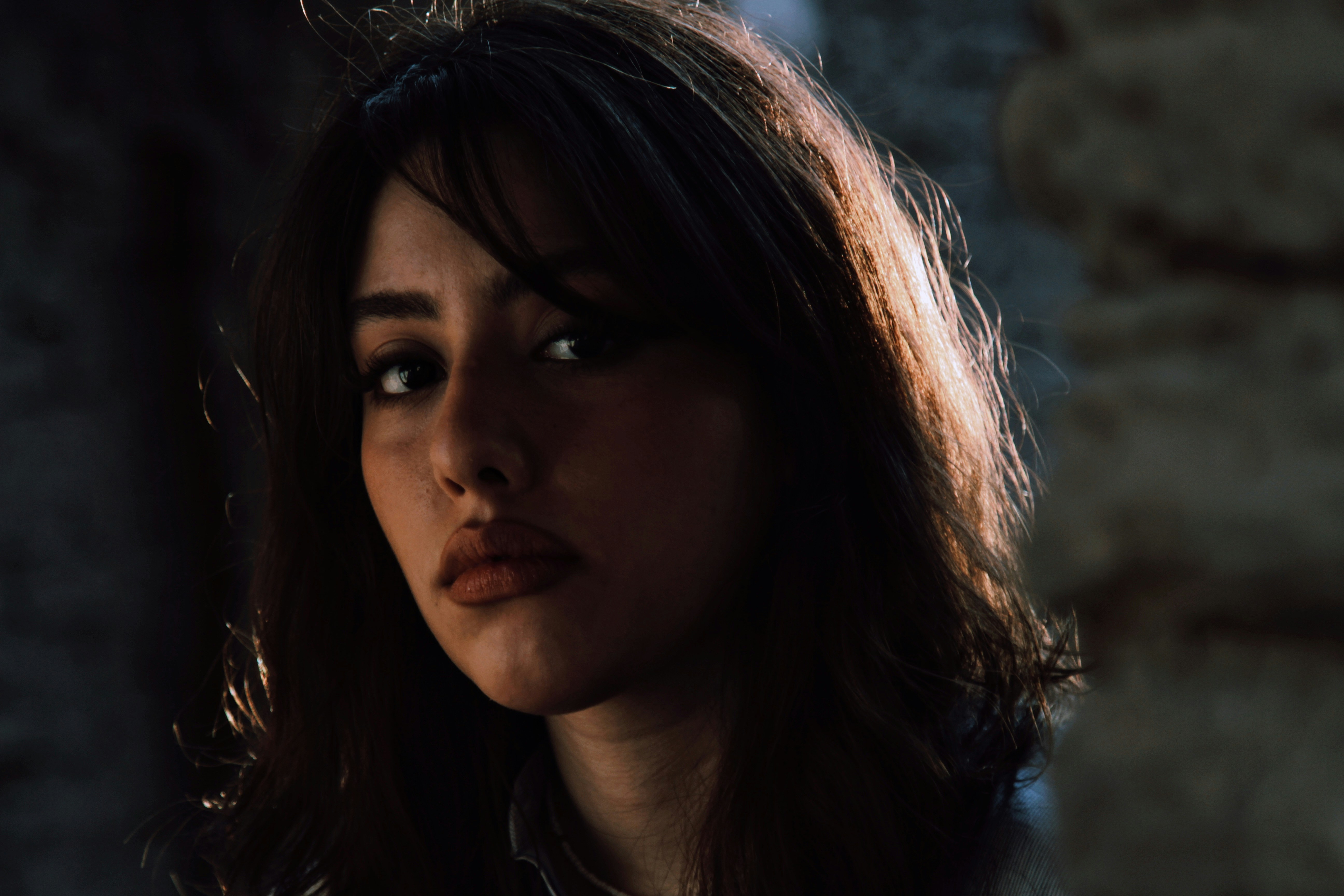 Young woman with dark hair looking forward