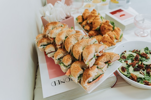 Assortment of bagels, croissants, and salad on a table